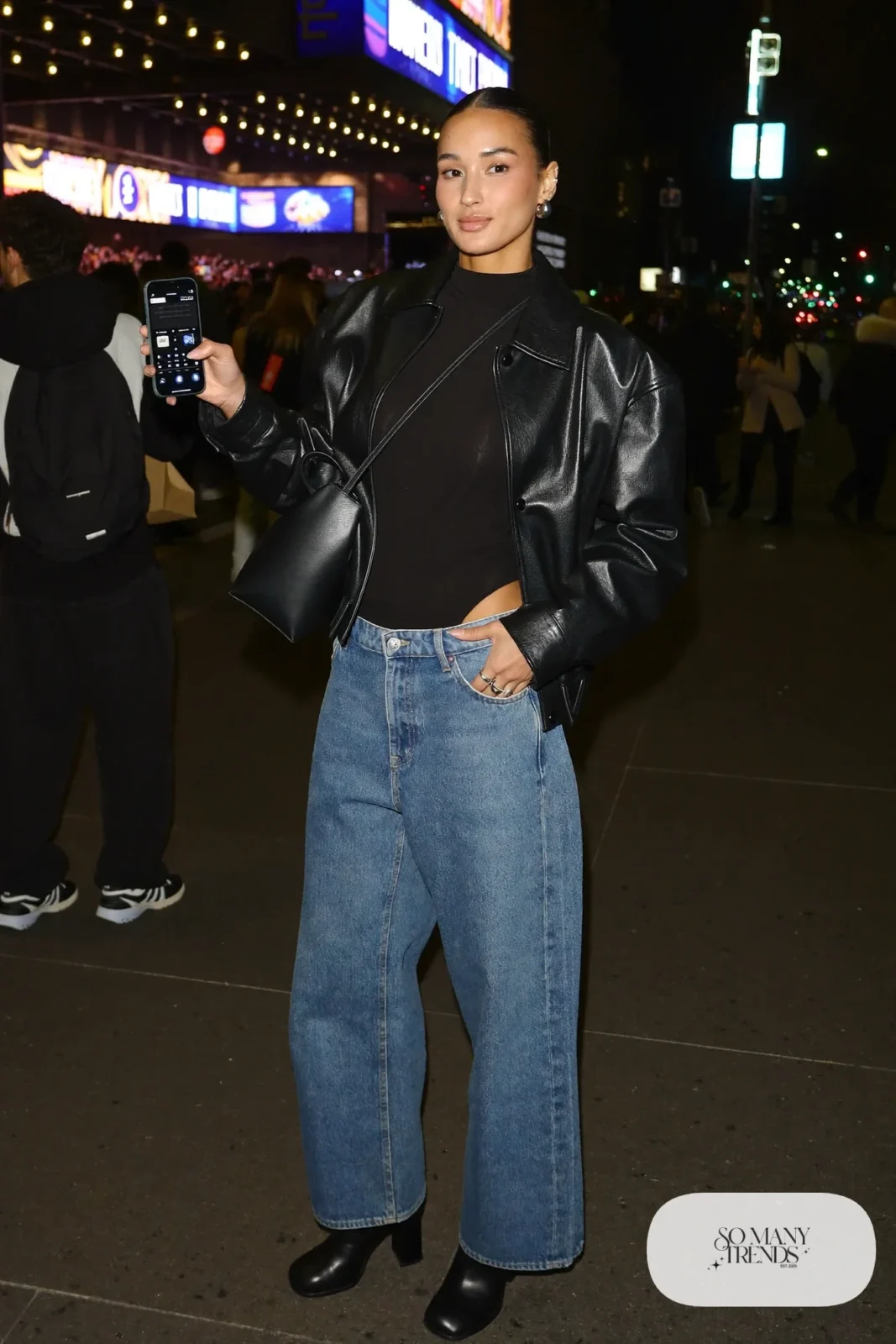 black long sleeve bodysuit high-waisted wide-leg jeans black leather jacket block heel boots crossbody bag outfit 16