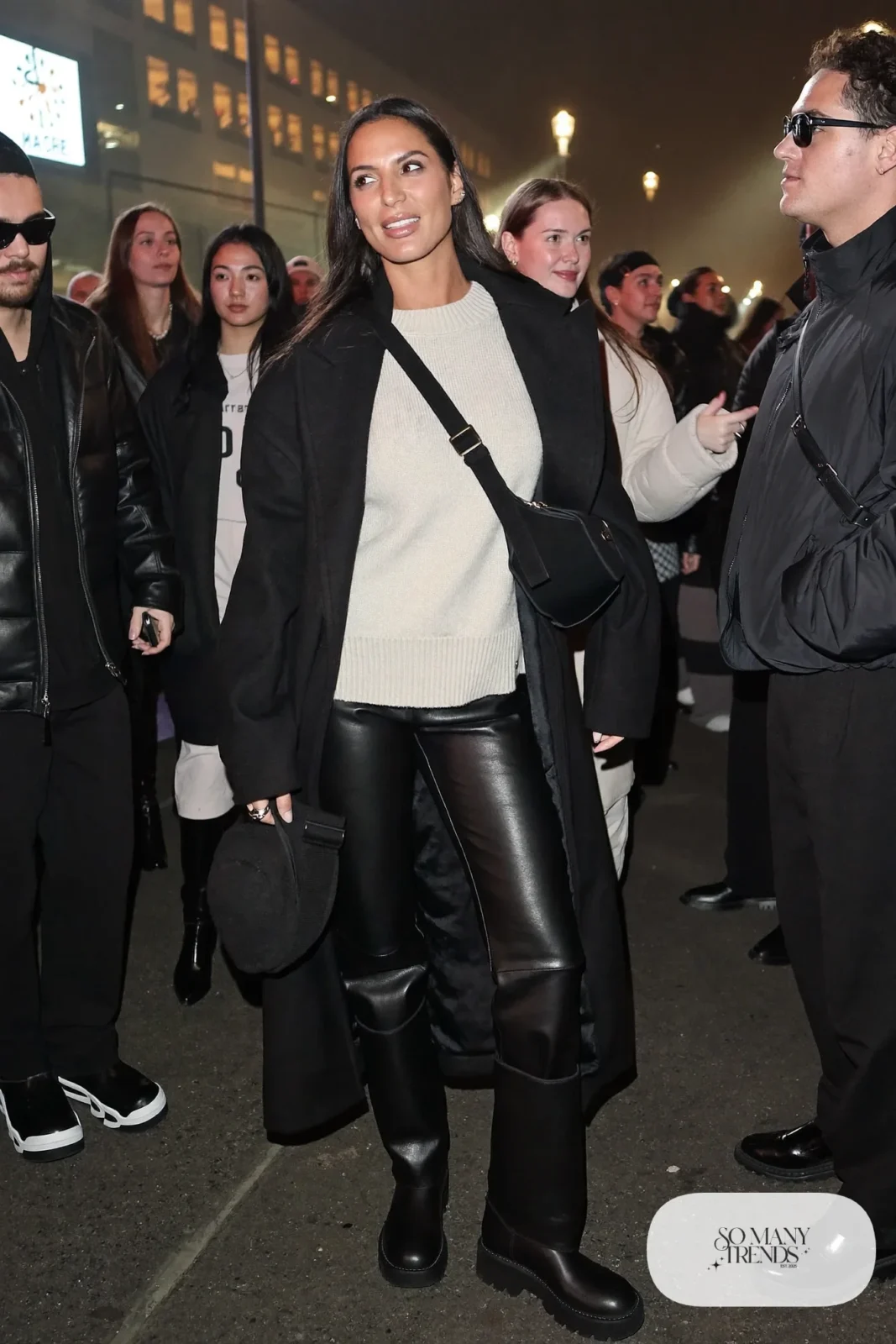 black faux leather straight pants cream chunky sweater long black coat lug sole boots crossbody bag outfit 21