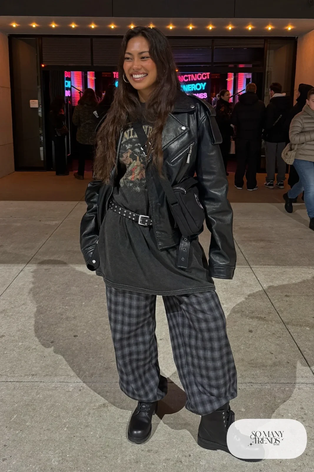 black faux leather moto jacket gray plaid wide-leg pants graphic tee black boots studded belt outfit 11
