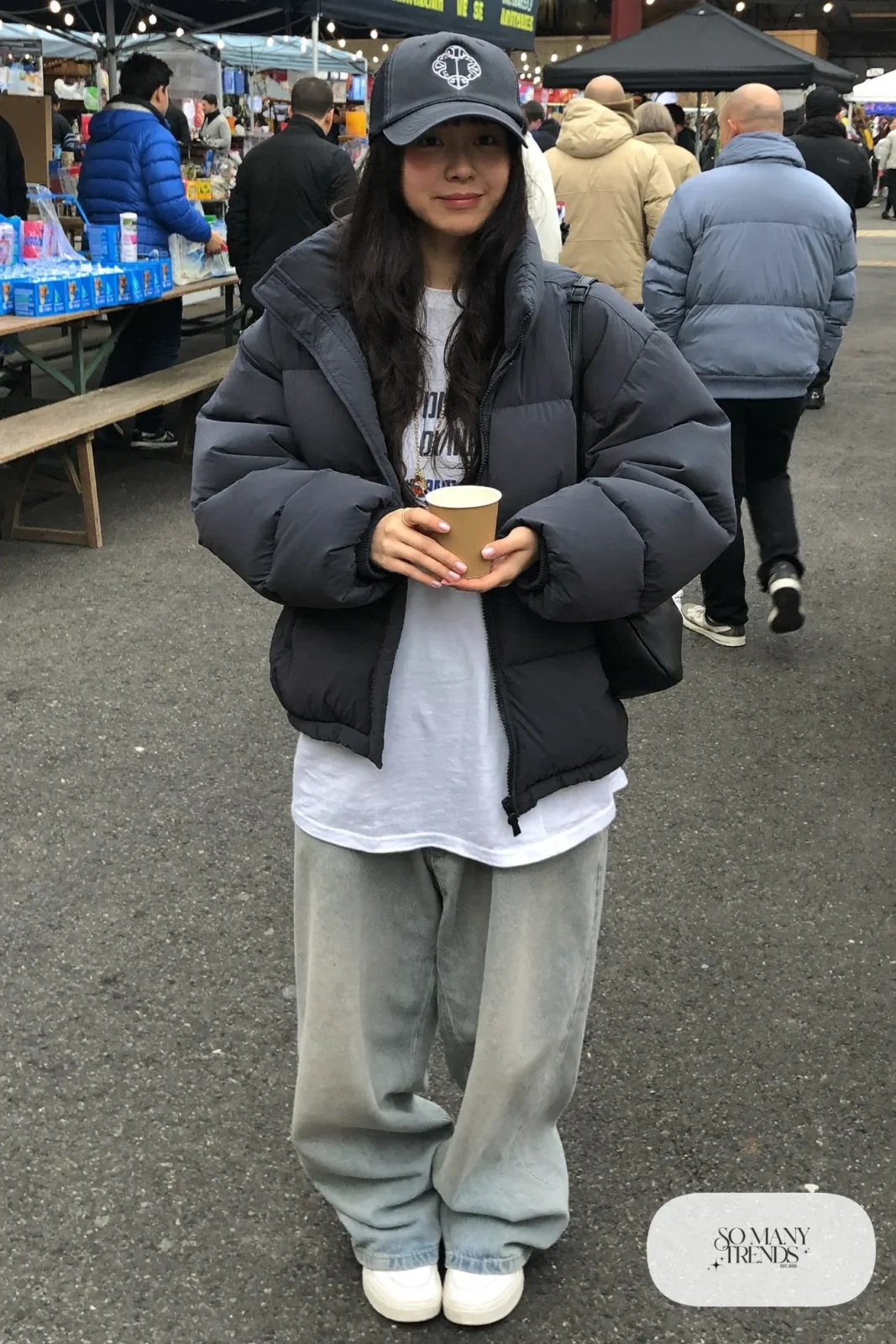 trucker hat gray puffer jacket baggy light-wash jeans graphic tee chunky sneakers crossbody bag outfit 17