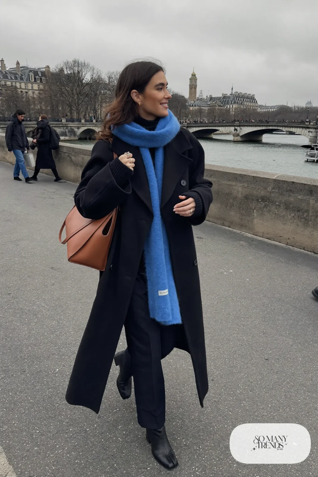 long black wool coat cobalt blue wool scarf black turtleneck straight-leg pants leather tote boots outfit 3