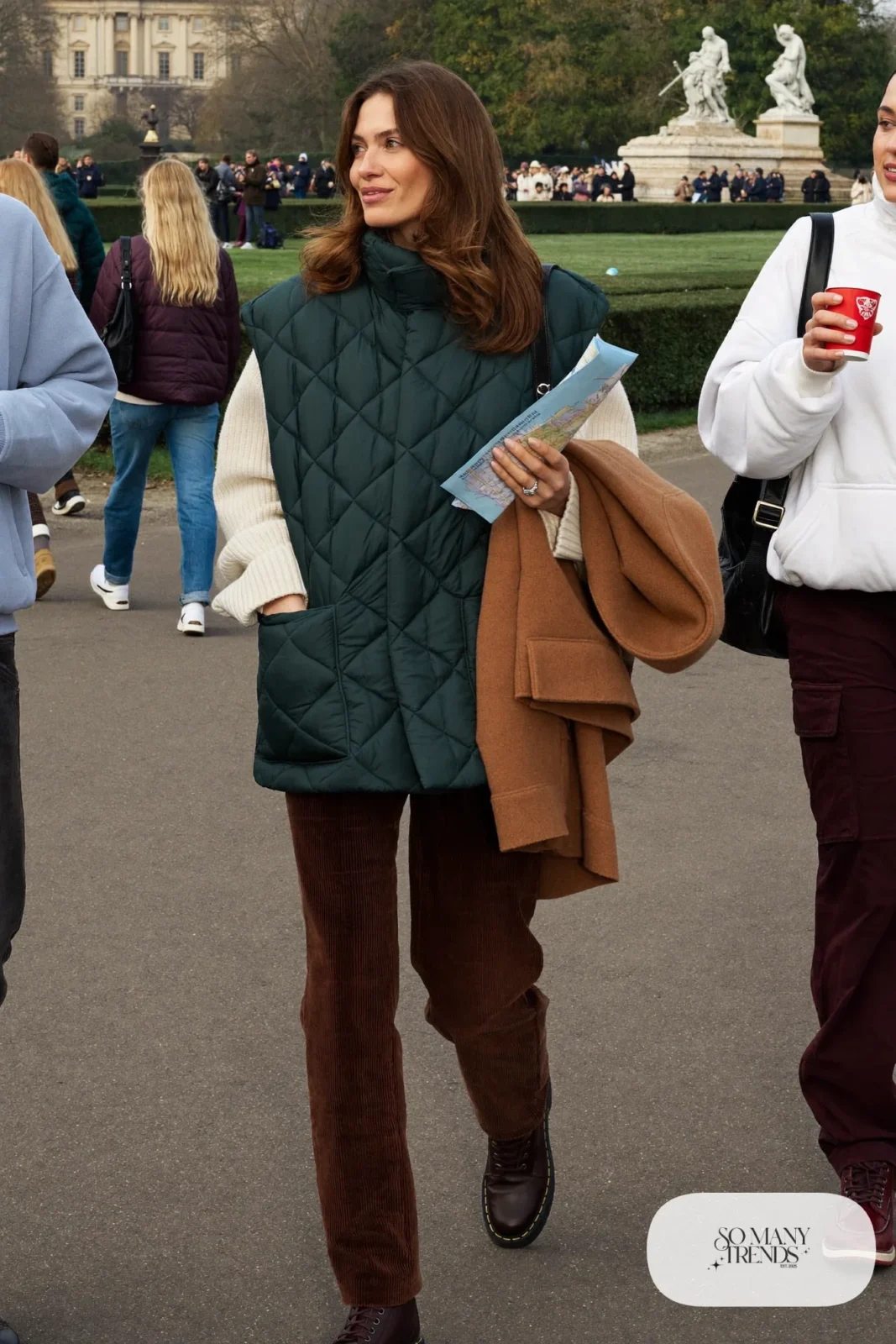 dark green quilted vest cream chunky knit sweater brown corduroy pants walking boots long wool coat outfit 31