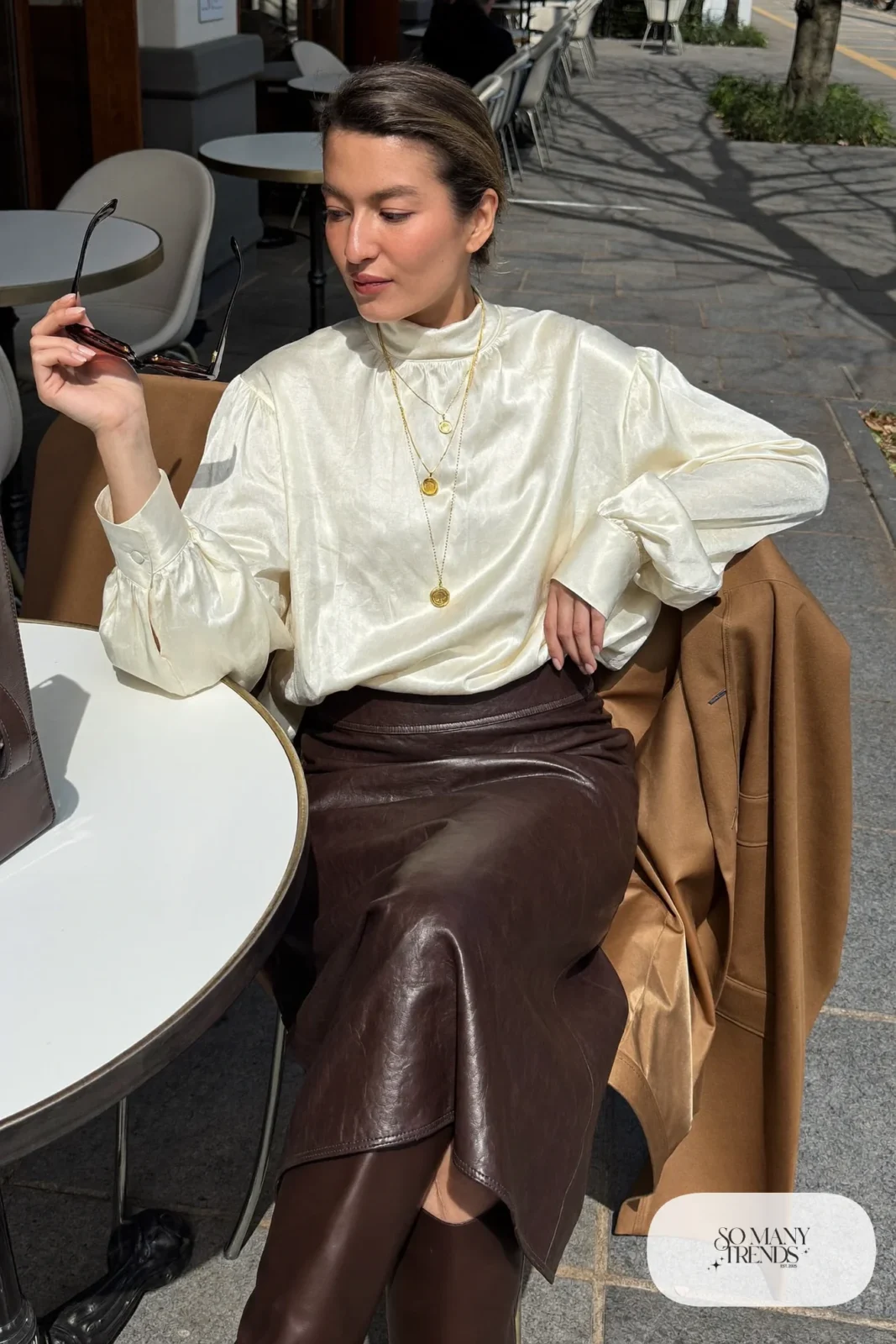 chocolate faux leather midi skirt cream blouse long camel coat boots outfit 27