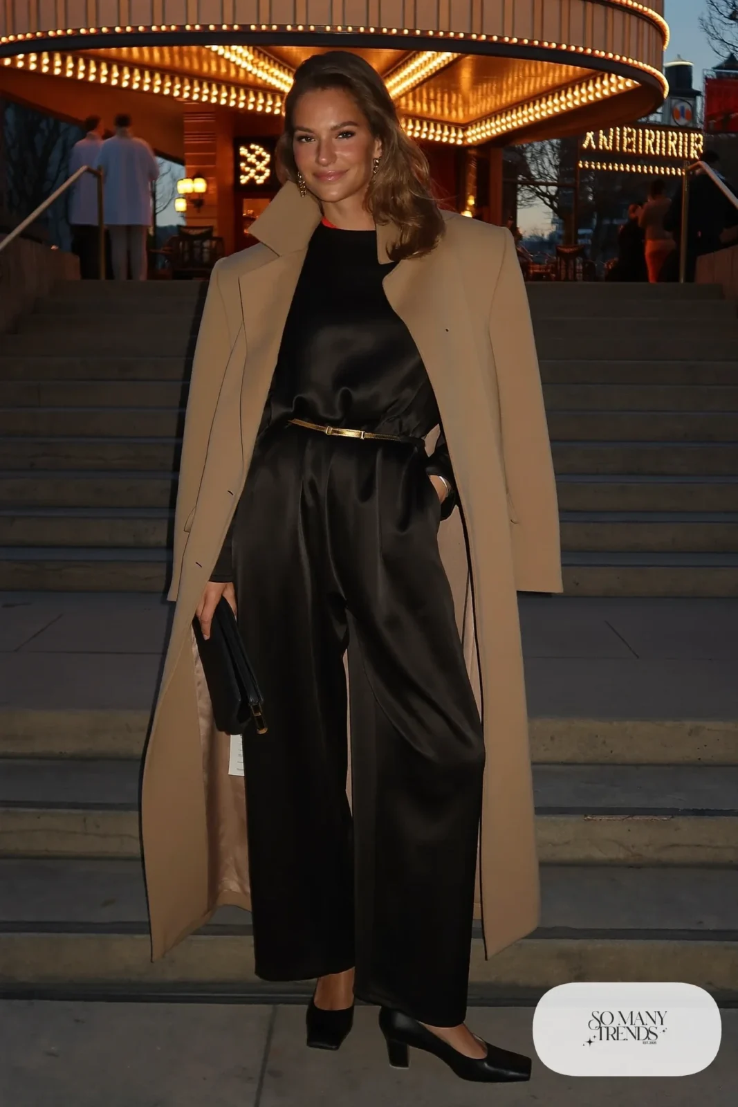 black satin wide-leg jumpsuit gold belt long coat black heels clutch outfit 28