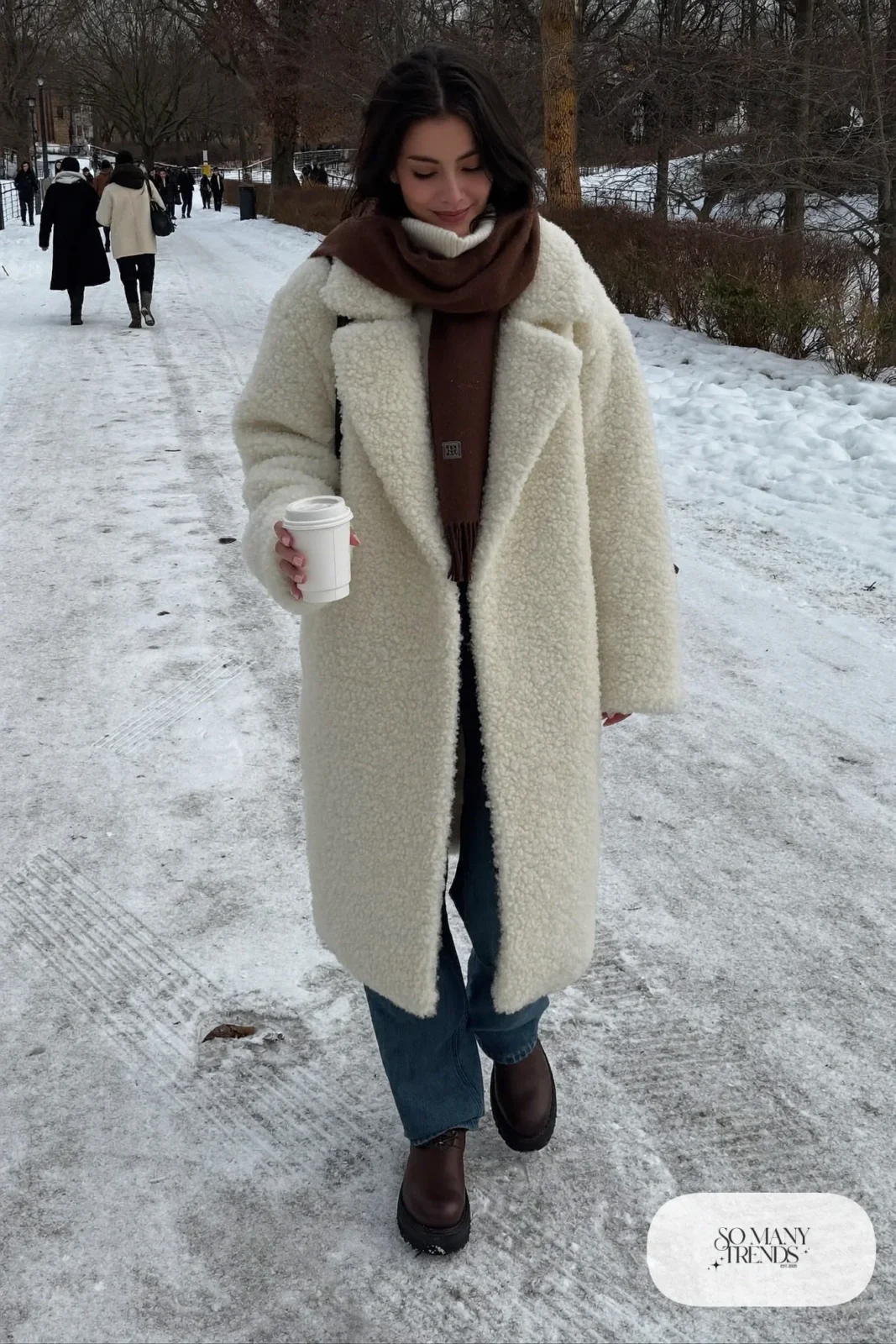 long ivory teddy coat dark straight jeans brown scarf brown leather boots outfit 1