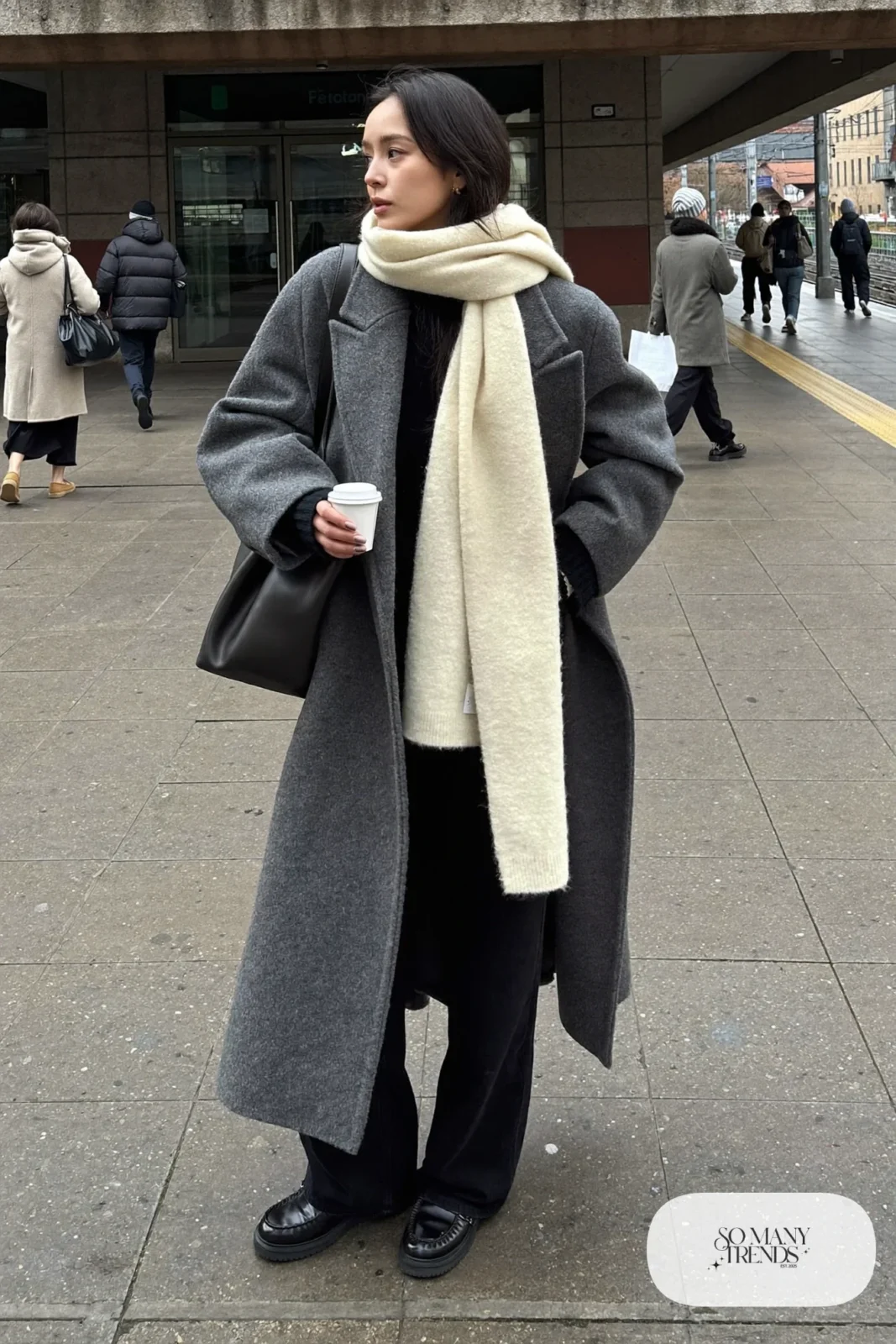 charcoal long wool coat cream cashmere scarf black wide-leg pants black loafers outfit 2