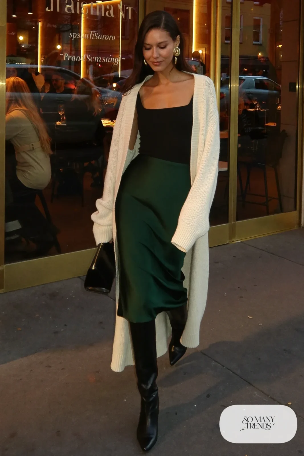 green satin midi skirt chunky cream cardigan black knee-high boots clutch outfit 12