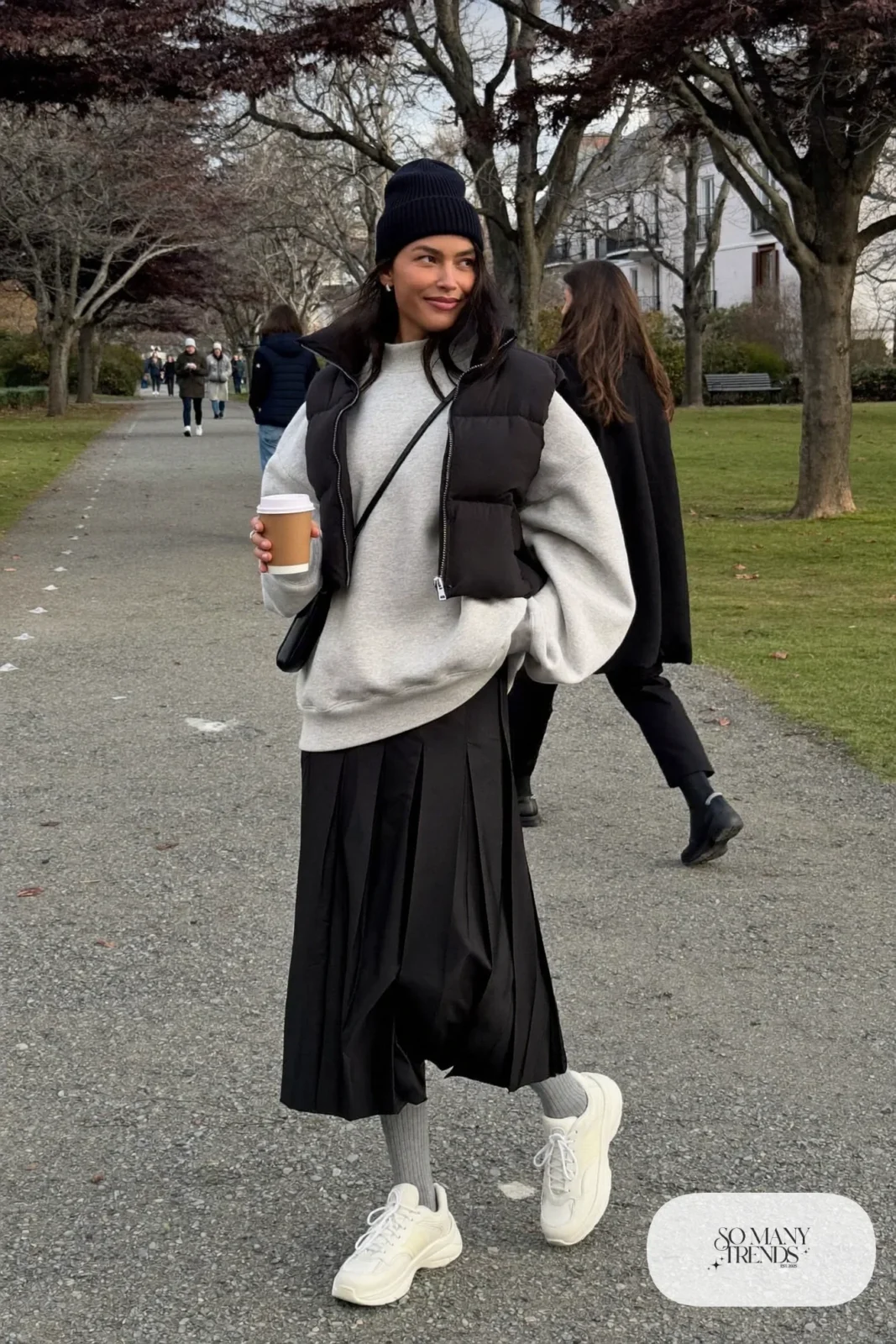 gray crewneck sweatshirt black pleated maxi skirt white sneakers puffer vest outfit 21