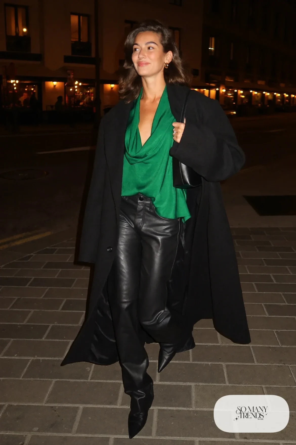 black faux leather straight pants emerald satin cowl neck top long black coat pointed boots outfit 17