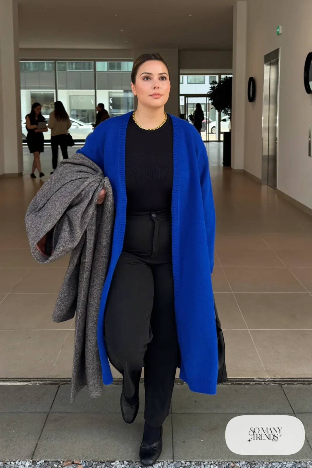 cobalt blue long knit cardigan black bodysuit high-waisted black straight pants black ballet flats gray overcoat outfit 4