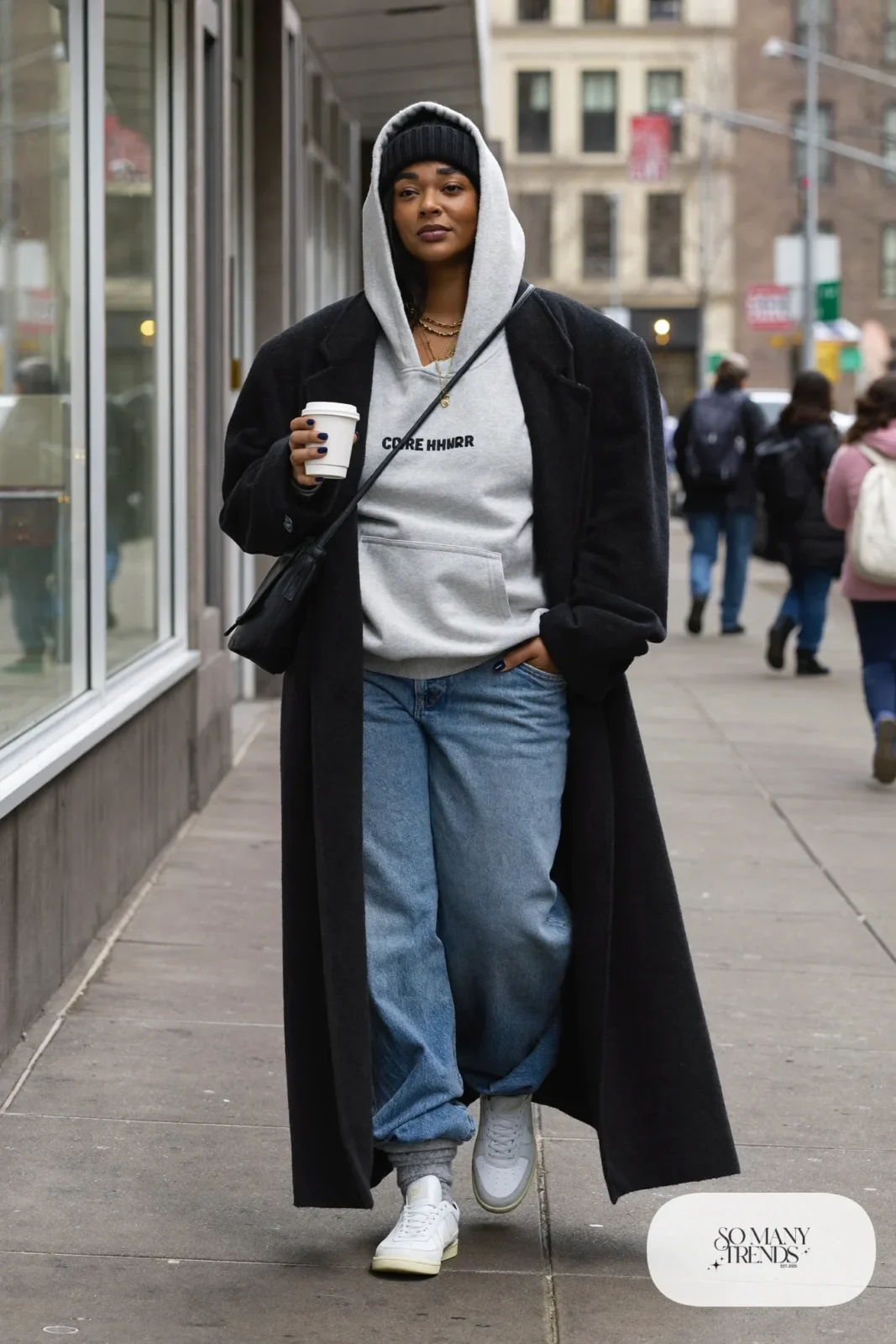 long black wool coat oversized heather gray hoodie light-wash wide-leg jeans white retro sneakers black beanie outfit 13