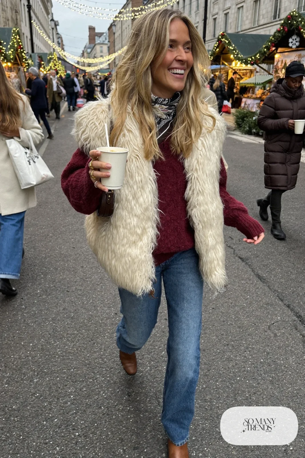 burgundy chunky knit sweater cream faux fur vest mid-blue straight jeans brown ankle boots silk bandana outfit 19