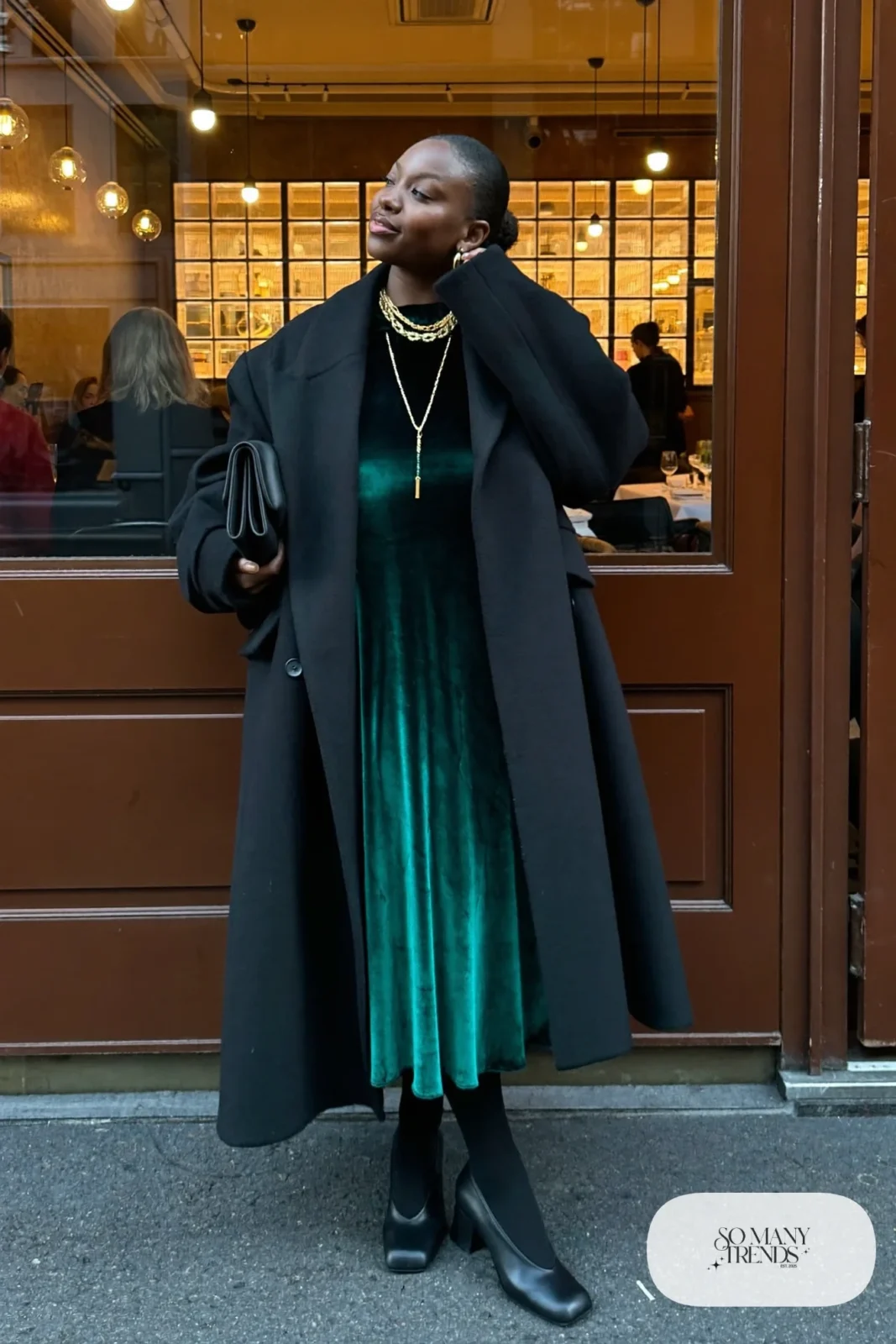 emerald green long-sleeve velvet midi dress long black wool coat sheer black tights black block-heel pumps gold necklaces outfit 20