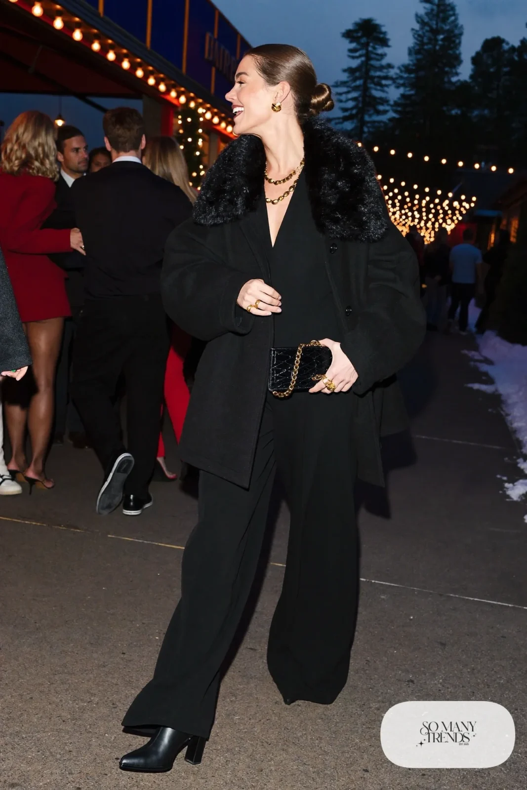 black long-sleeve wide-leg crepe jumpsuit oversized black wool jacket faux fur collar black block-heel boots gold earrings outfit 26