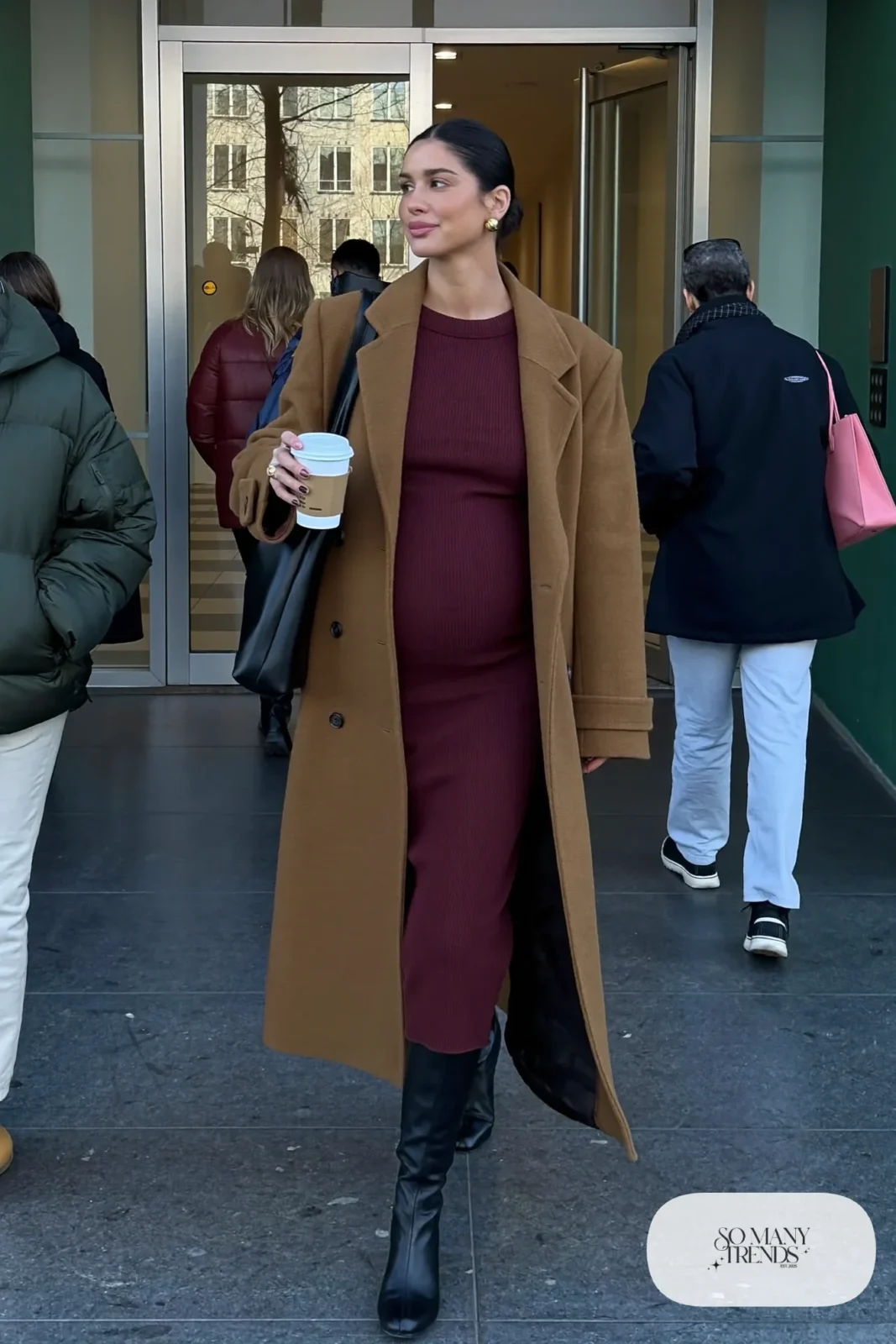 pregnant woman in burgundy ribbed knit dress, open camel wool coat, black ankle-length tall boots and structured tote, outfit 1