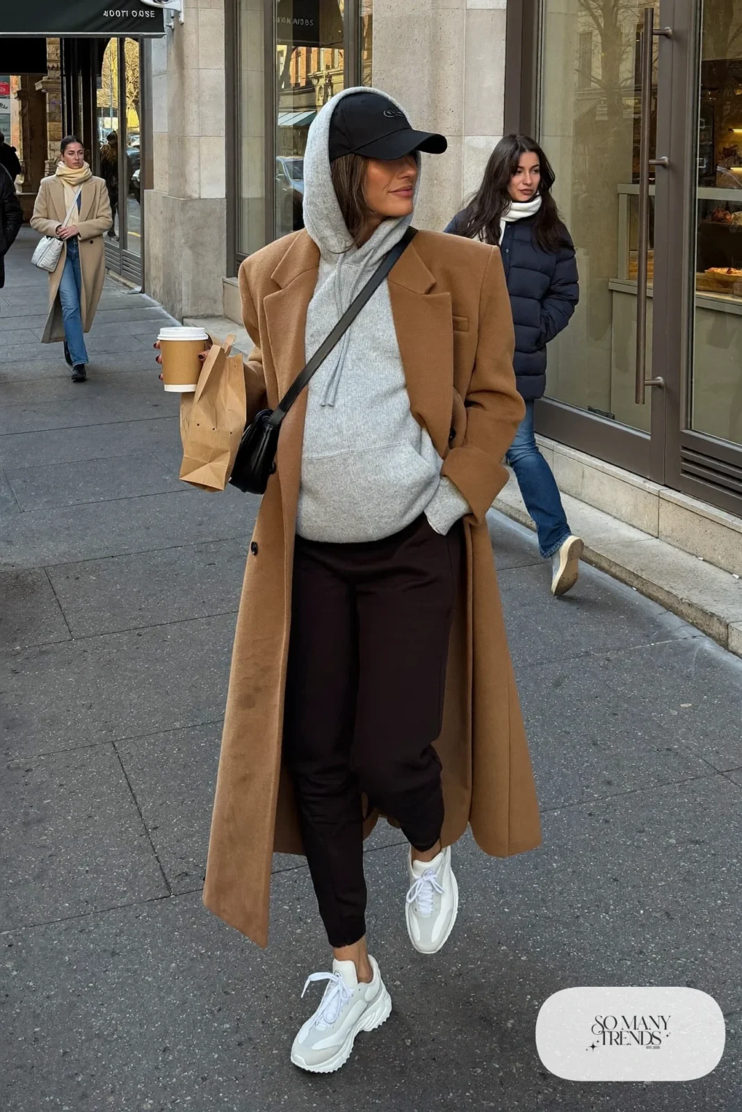 pregnant woman in oversized gray hoodie, camel wool coat, black maternity joggers and white sneakers, outfit 14
