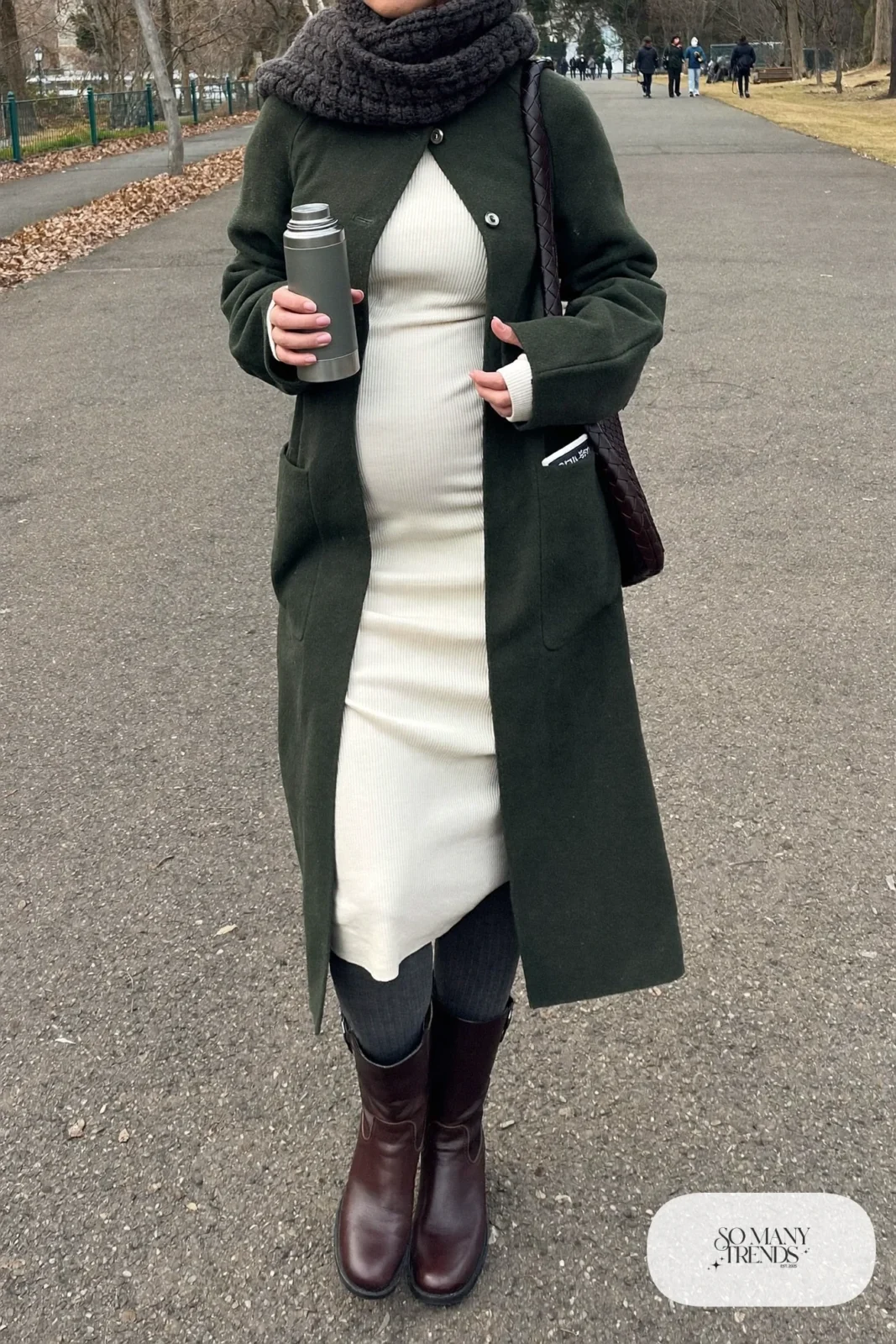 pregnant woman in forest green long cardigan, cream ribbed dress, knit tights and ankle boots, outfit 15