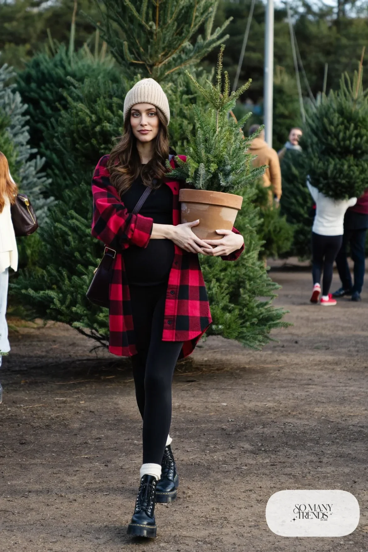 pregnant woman in red plaid flannel shirt worn open, black maternity tee, black leggings and chunky boots, outfit 16