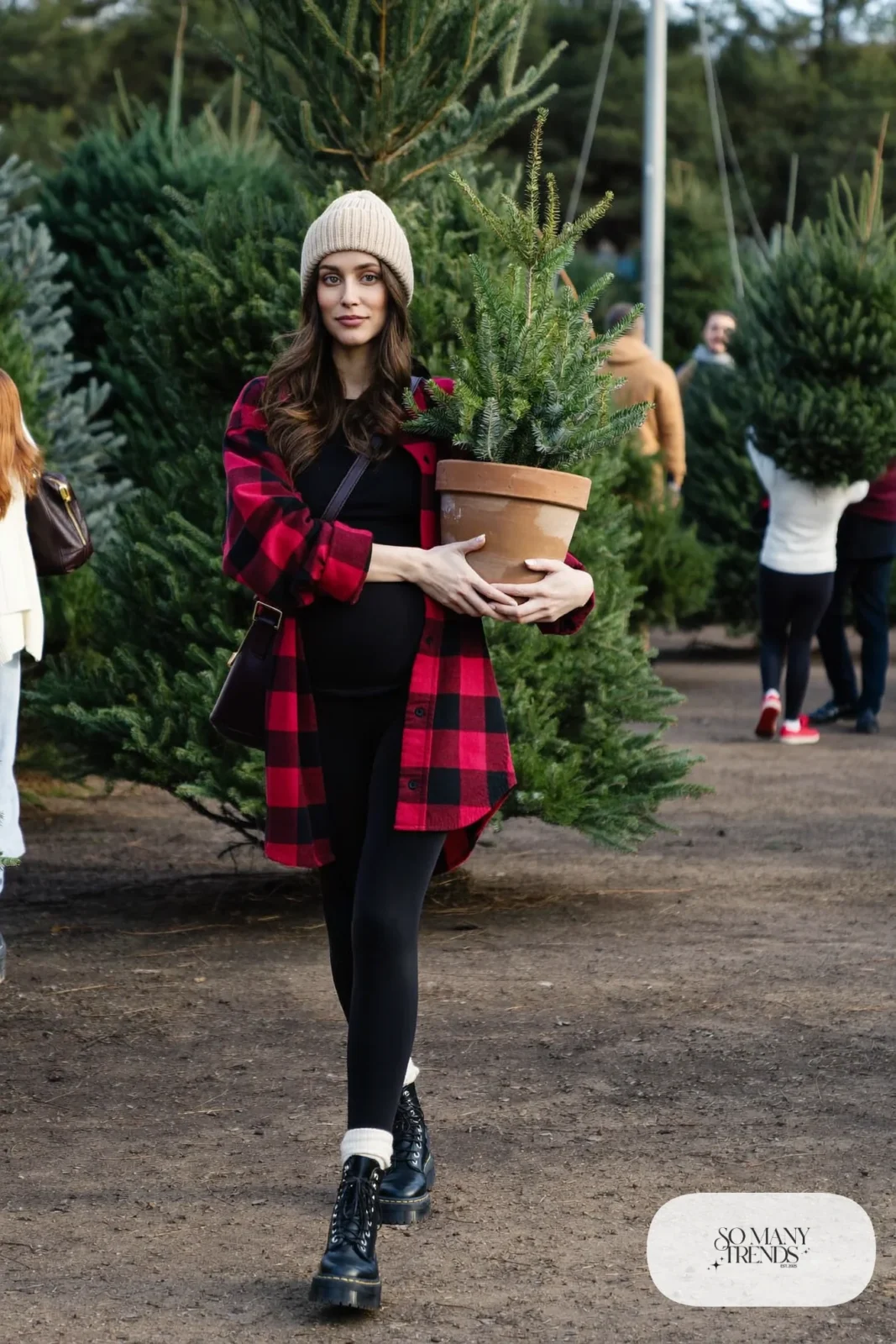 pregnant woman in red plaid flannel shirt worn open, black maternity tee, black leggings and chunky boots, outfit 16