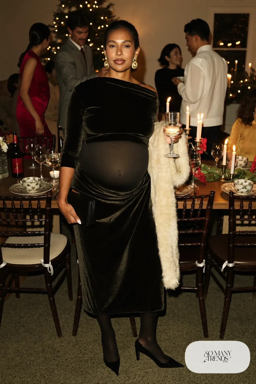 pregnant woman in black velvet wrap midi dress, sheer black tights, block-heel pumps and gold earrings, outfit 20