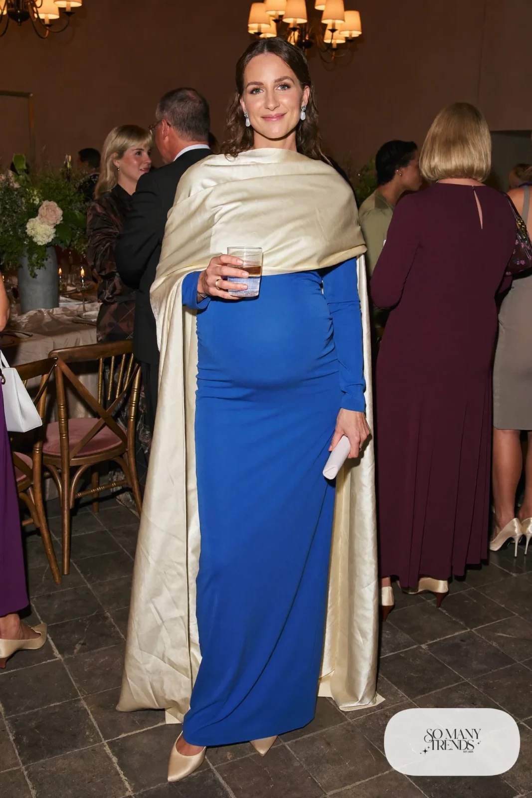 pregnant woman in cobalt blue empire-waist maternity gown, satin closed-toe low-heel pumps, wrap shawl and clutch, outfit 23