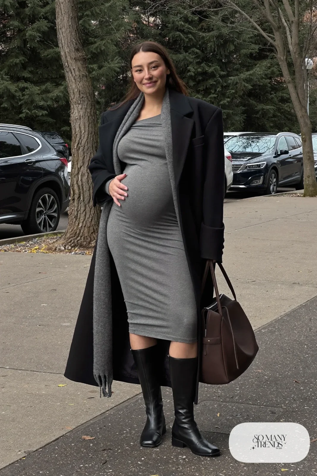 pregnant woman in oversized black wool coat, gray knit dress, black ankle boots and overnight bag, outfit 26