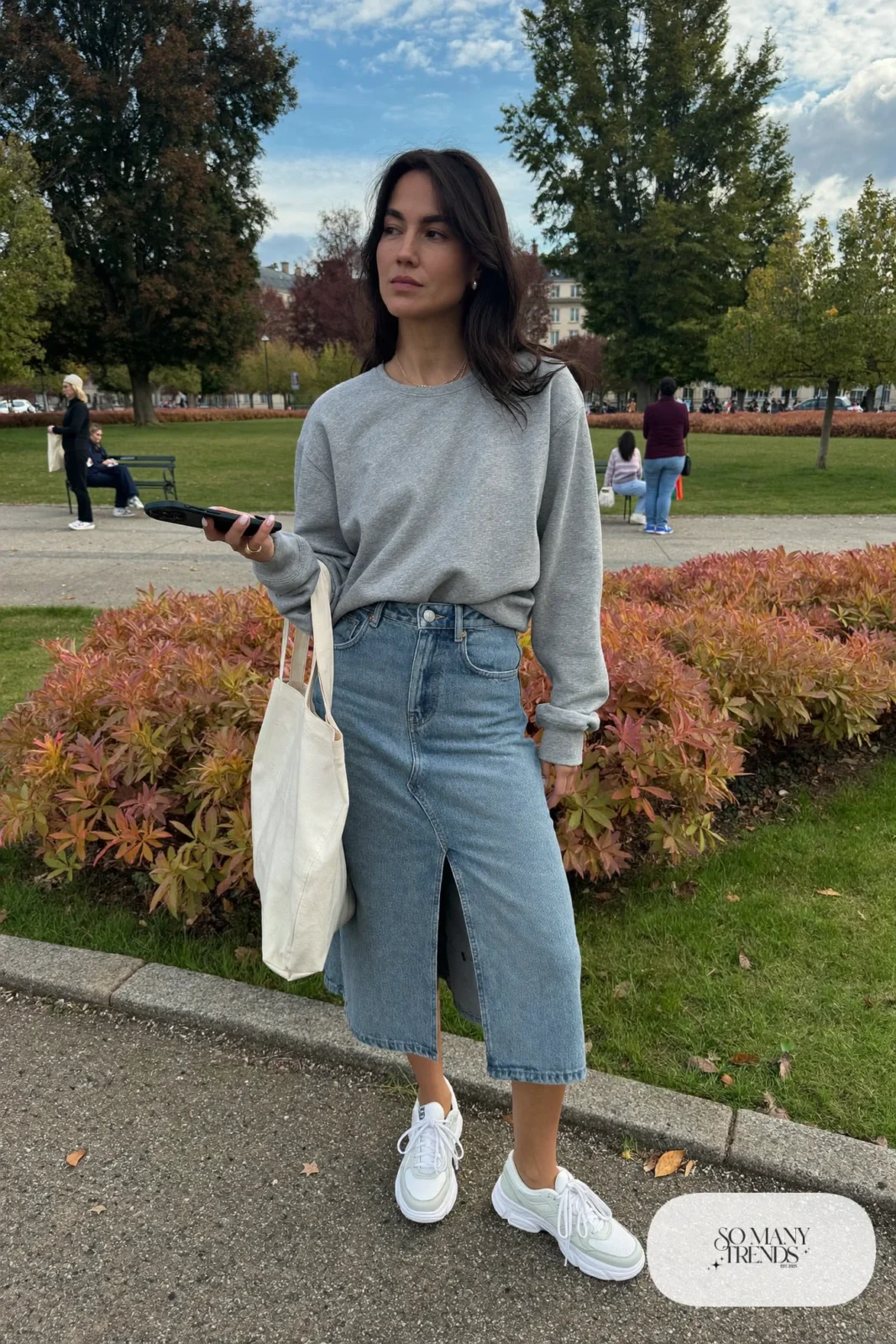 mid-wash denim A-line midi skirt gray crewneck sweatshirt white sneakers tote outfit 11