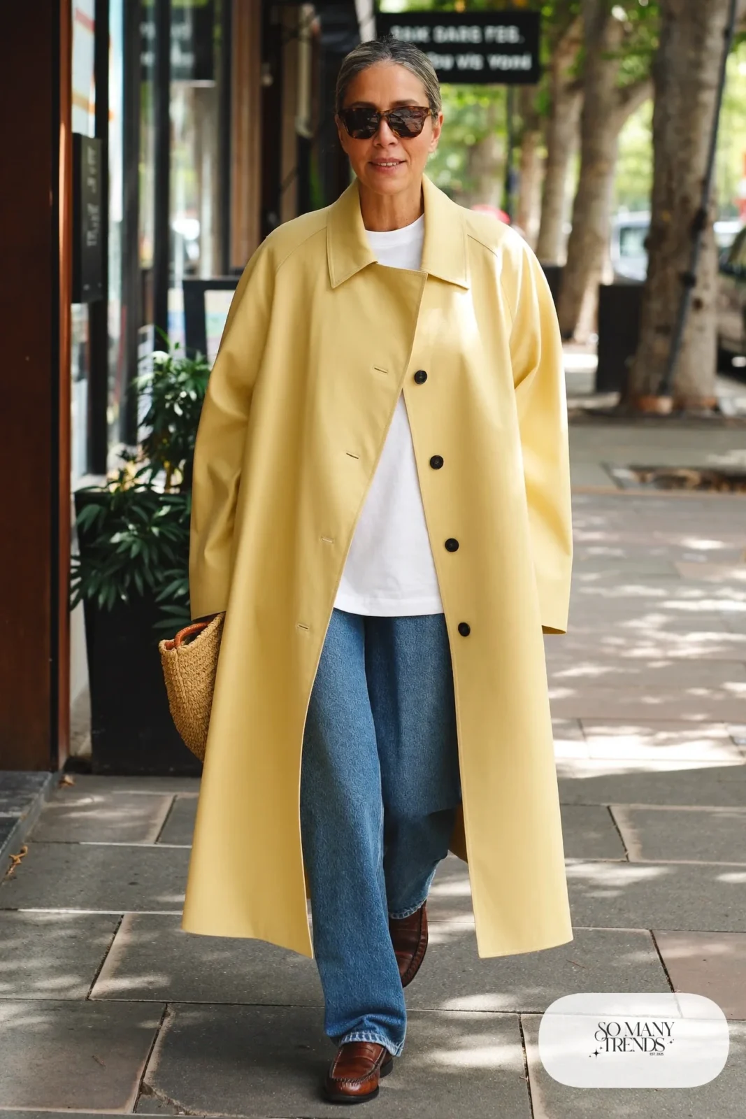butter yellow trench coat white tee straight jeans loafers straw bag outfit 26