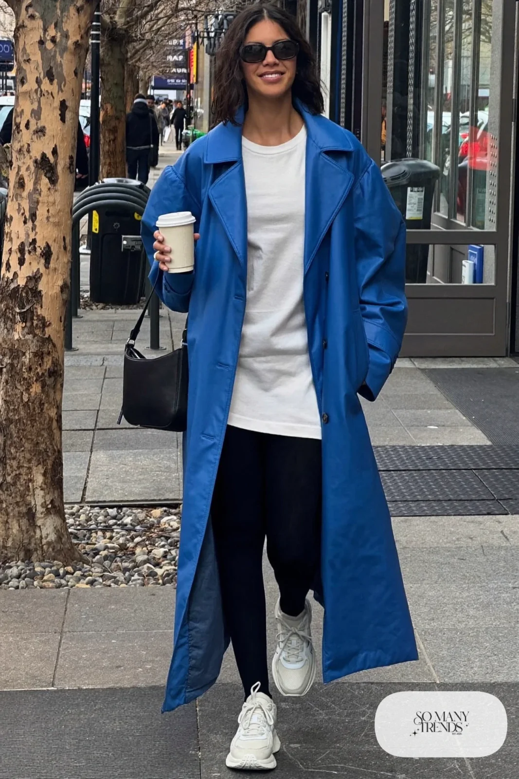 long cobalt blue trench coat thick black leggings white tee chunky sneakers small bag errand outfit 21
