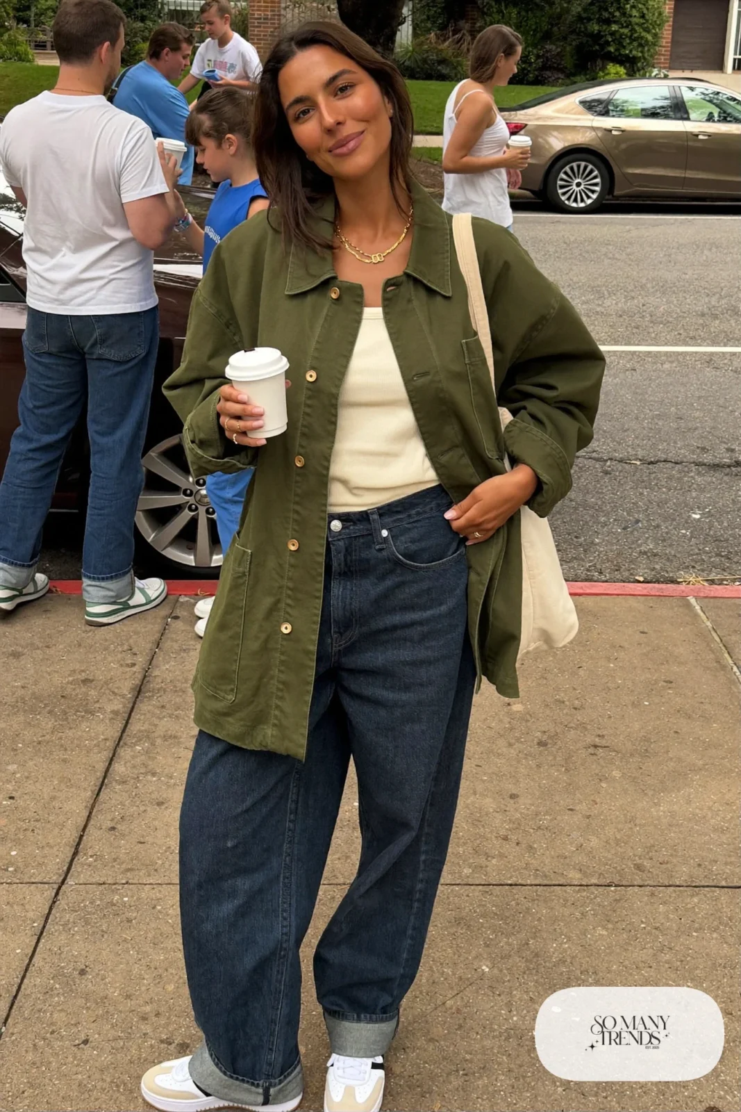 olive oversized utility jacket cream knit sweater wide-leg indigo jeans white sneakers canvas tote outfit 1