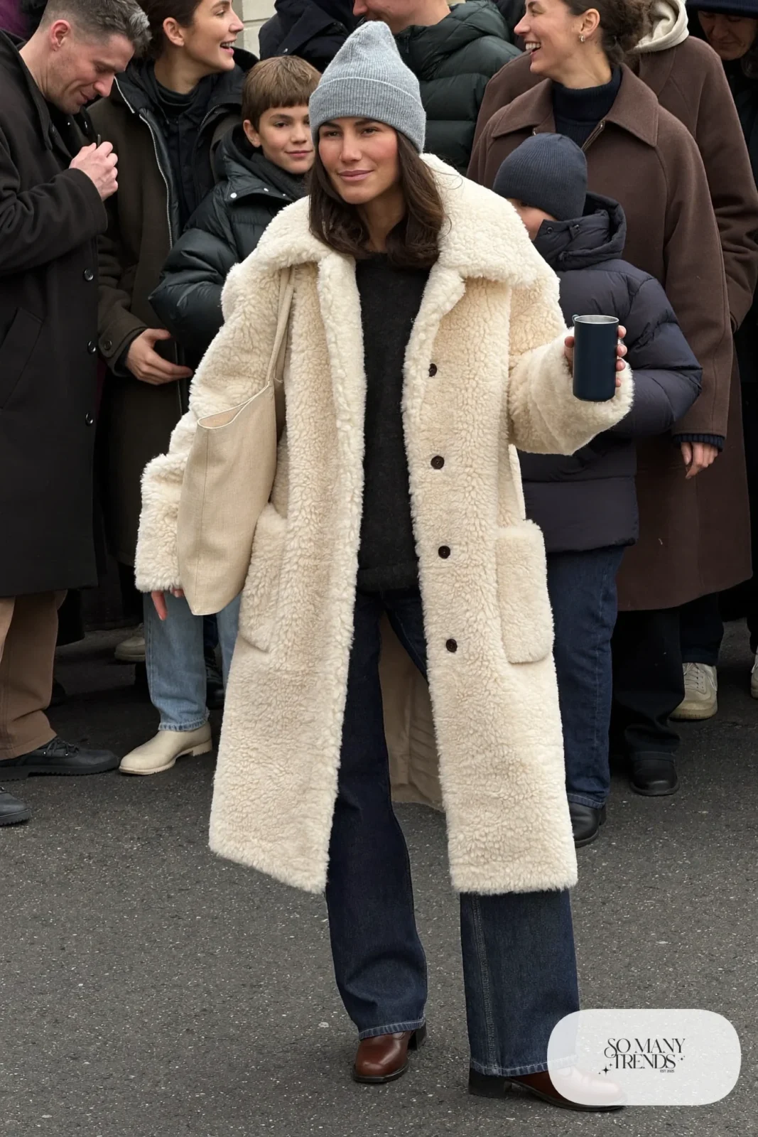 cream faux shearling jacket black sweater dark jeans brown boots beanie outfit 27