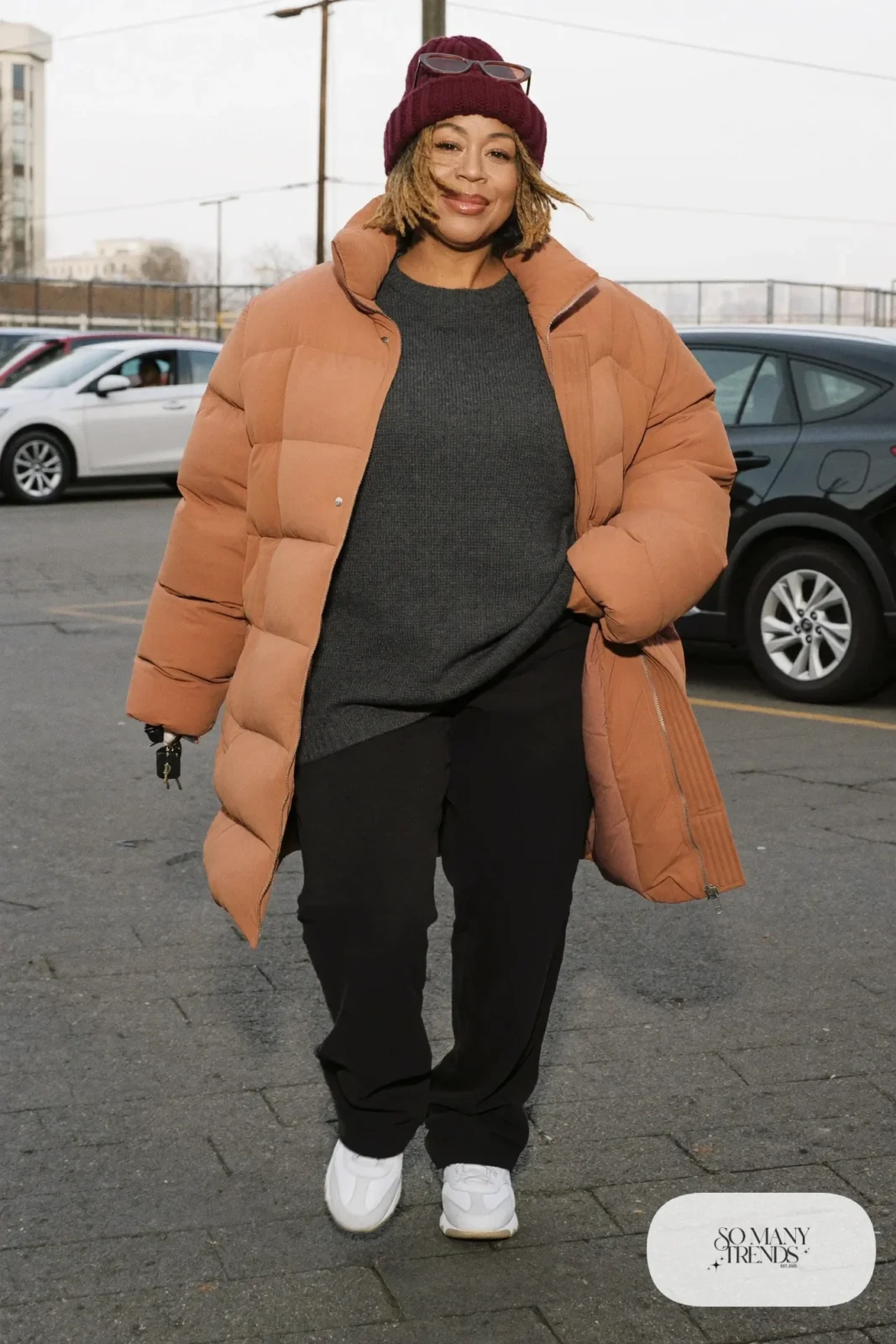 camel long puffer jacket charcoal ribbed sweater black pants sneakers outfit 3