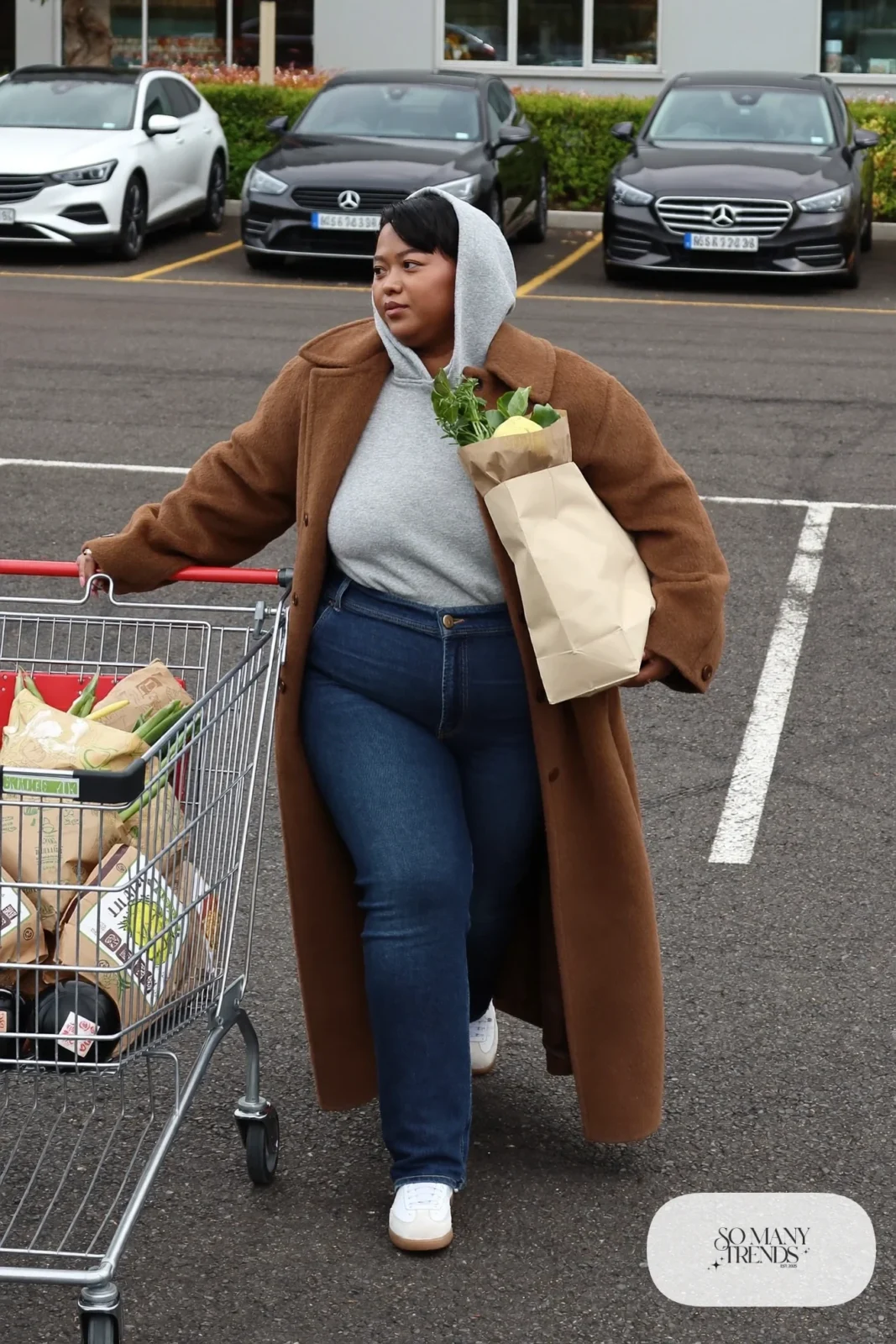 gray hoodie camel long coat dark jeans white sneakers outfit 17