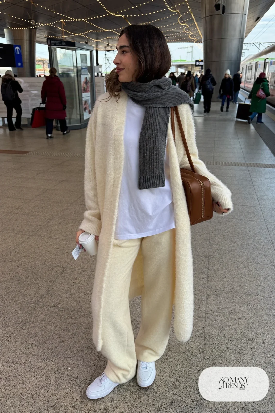 cream knit cardigan matching wide-leg knit pants oversized scarf white sneakers carry-on bag outfit 21