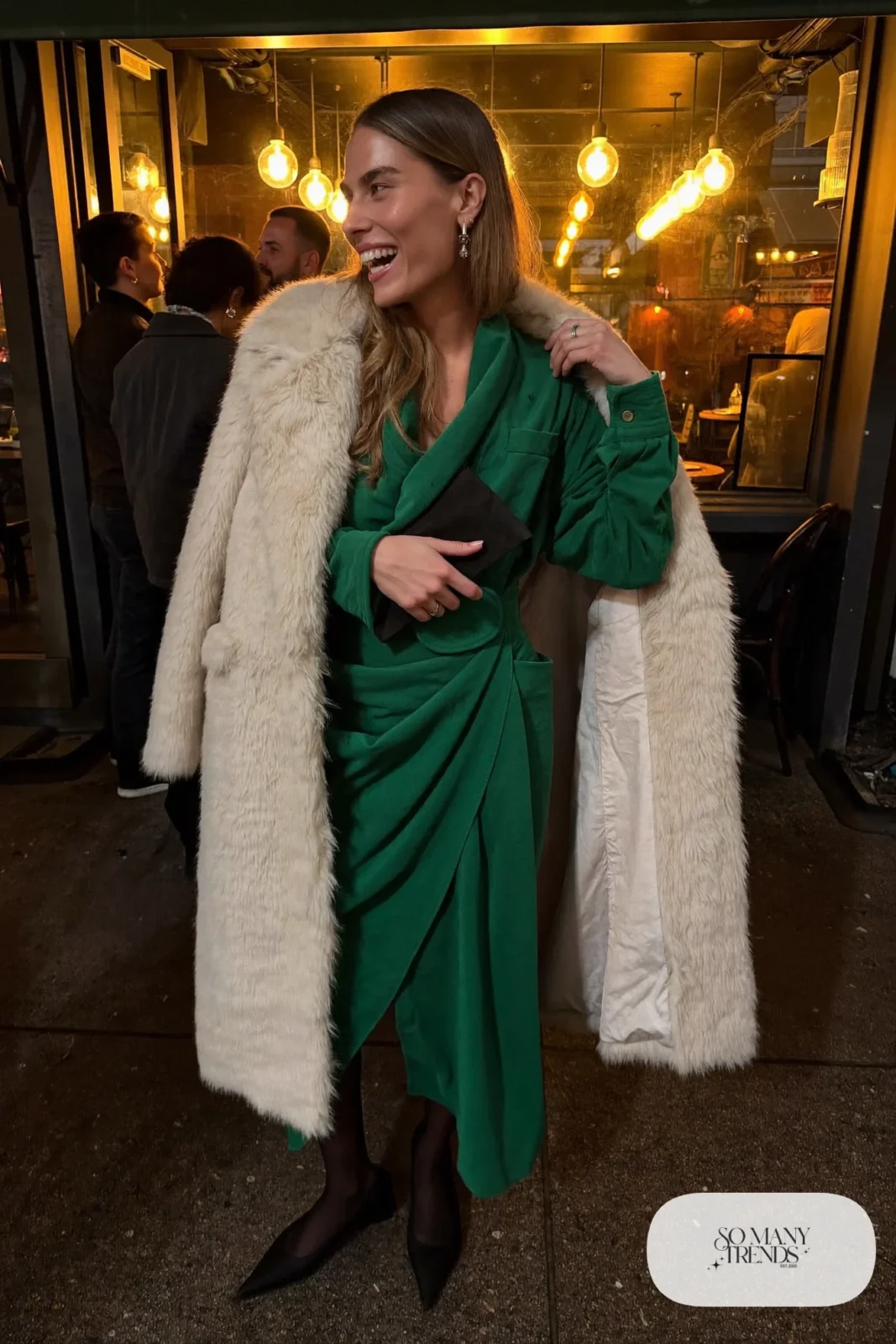 emerald green long sleeve wrap midi dress cream faux fur coat black pointed pumps sheer tights clutch outfit 10