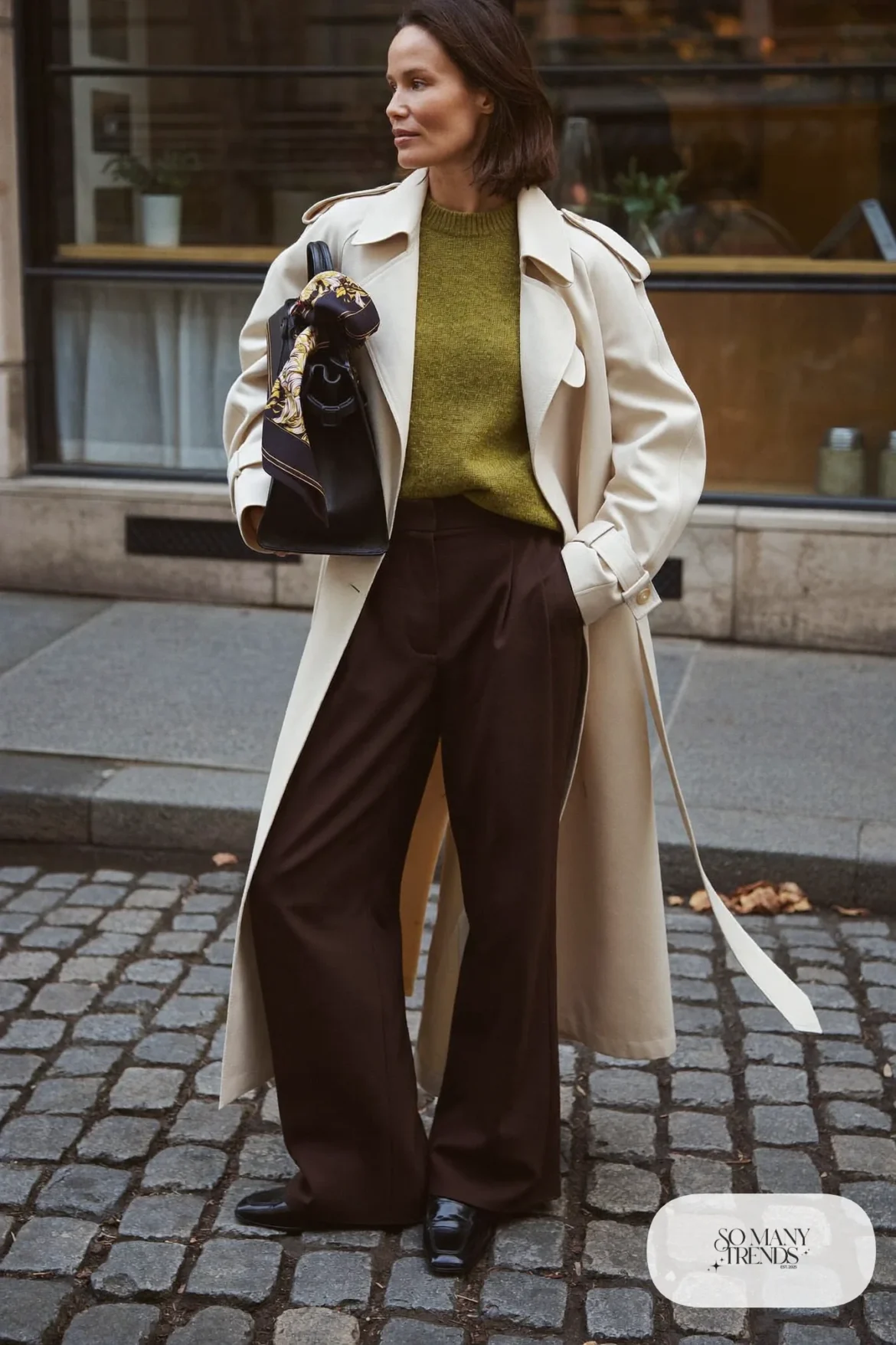 cream trench coat olive knit sweater brown wide-leg pants black loafers silk scarf outfit 9