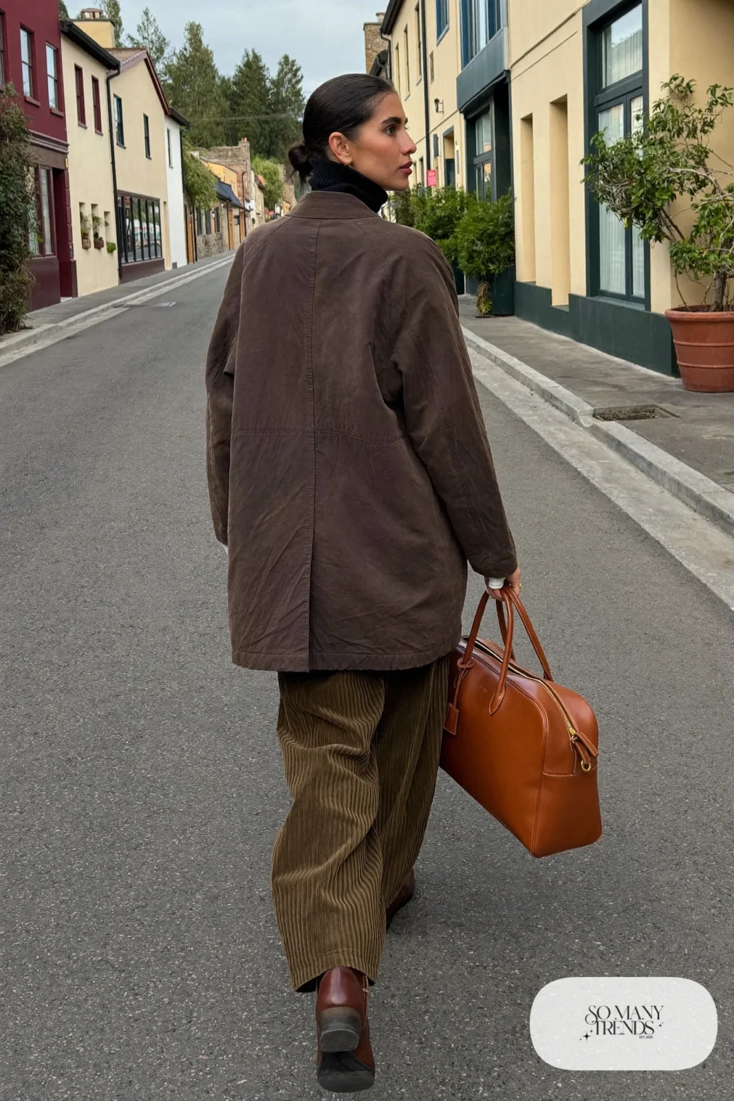 stone car coat olive corduroy straight pants black turtleneck brown boots weekender bag outfit 30