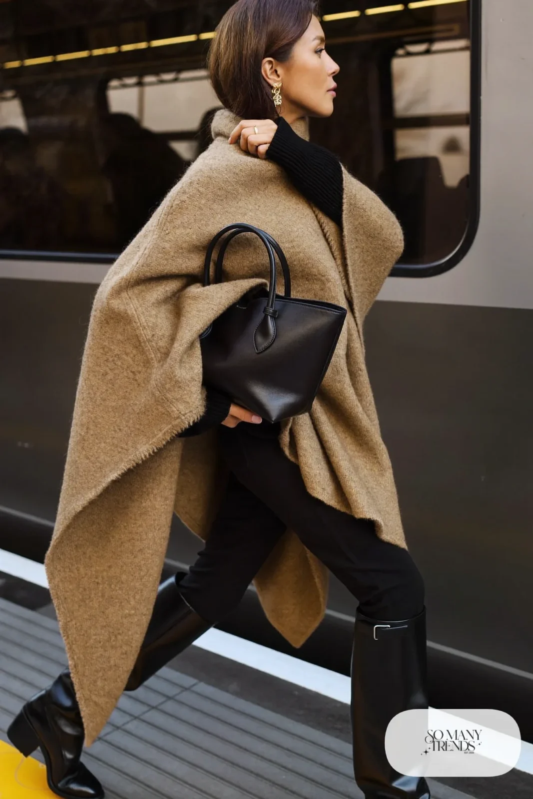 camel wool poncho black fitted knit slim black pants tall black boots leather tote travel outfit 32