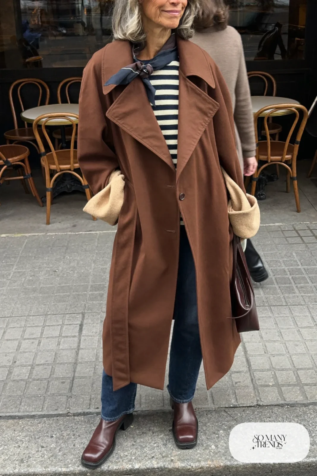 camel belted trench coat navy cream striped sweater dark jeans brown ankle boots outfit 7