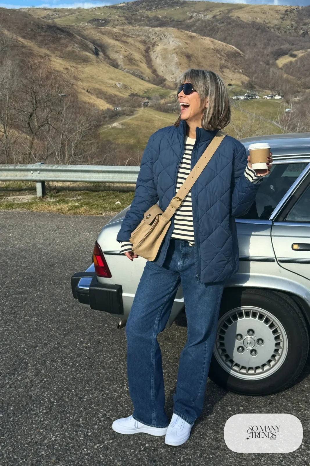 navy quilted jacket striped long sleeve tee straight jeans white sneakers crossbody bag outfit 22