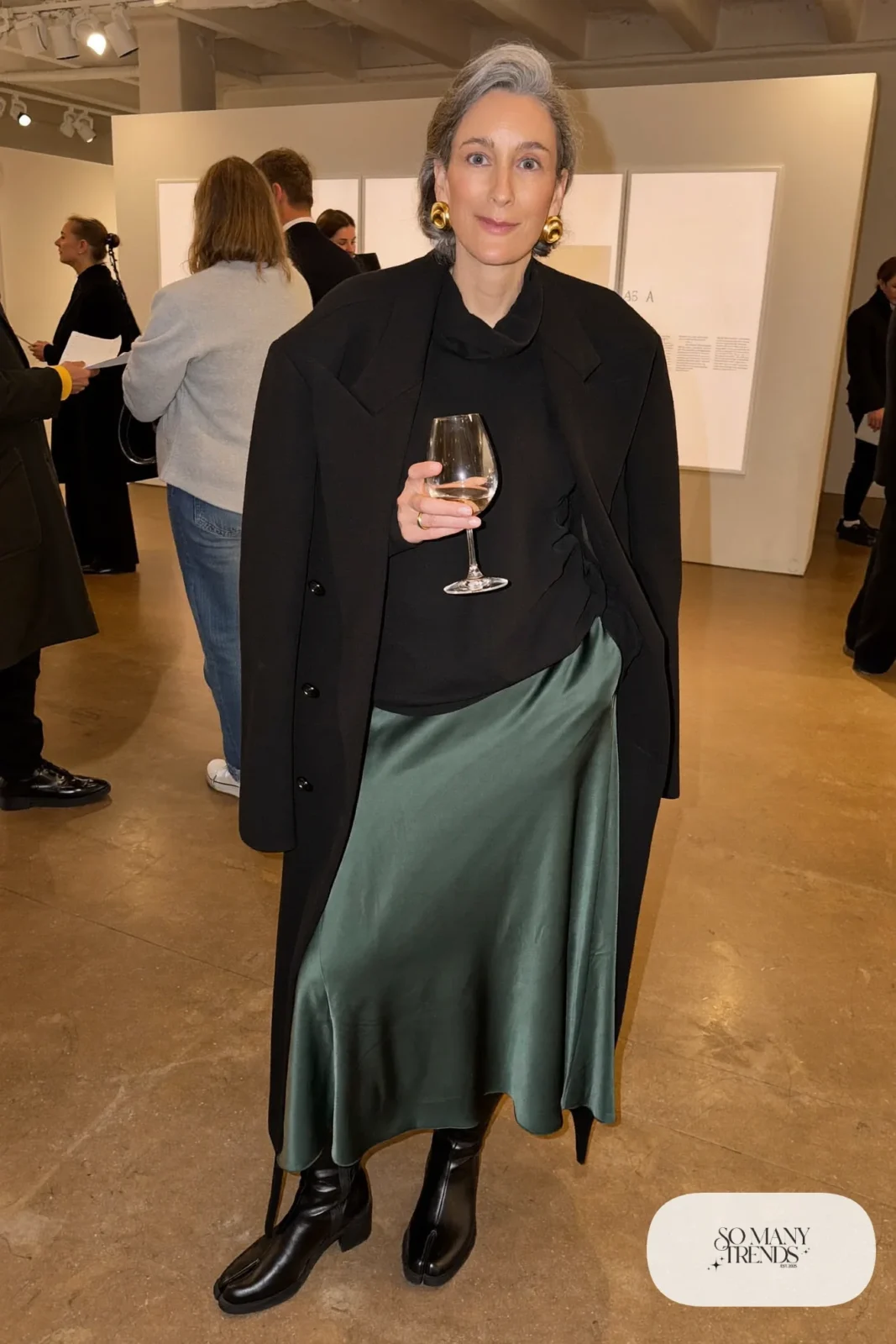 deep green satin midi skirt roomy black turtleneck knee-high black boots statement earrings outfit 26