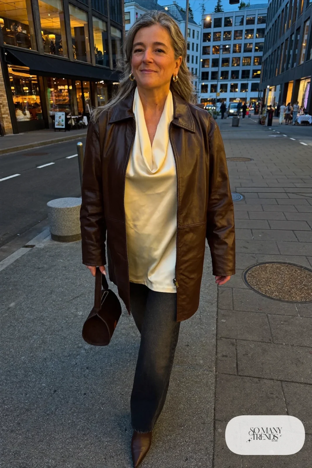 chocolate brown faux leather jacket cream silk blouse dark wide-leg jeans leather ankle boots gold hoops outfit 30