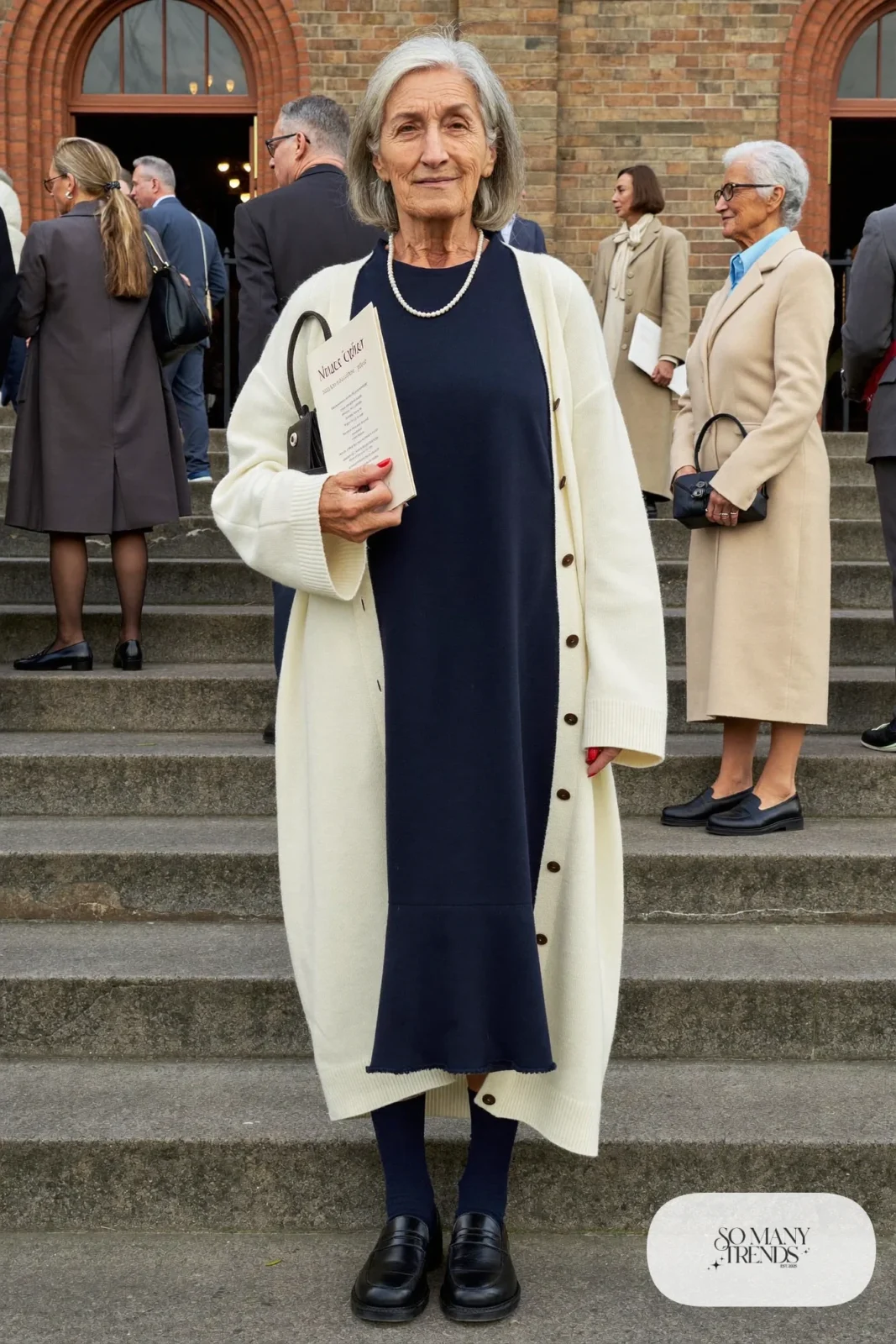 navy knit midi dress with long cream cardigan, pearl necklace and black leather loafers outfit 1