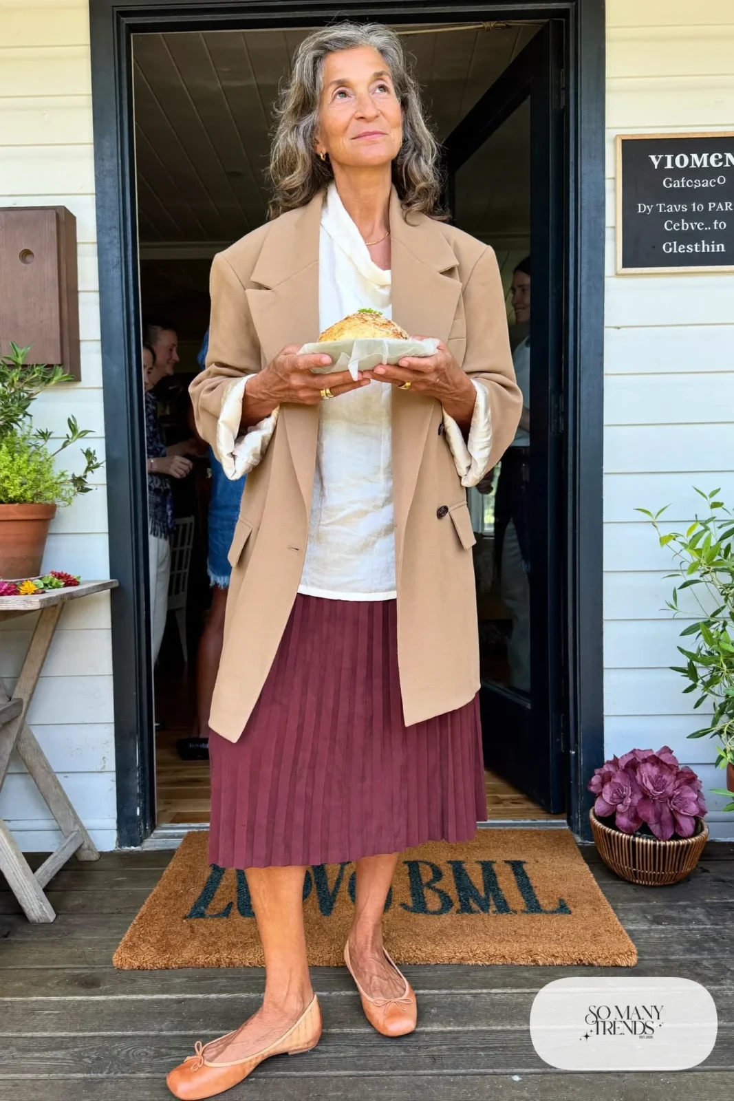 burgundy pleated midi skirt with ivory blouse, oversized camel blazer and tan flats outfit 2