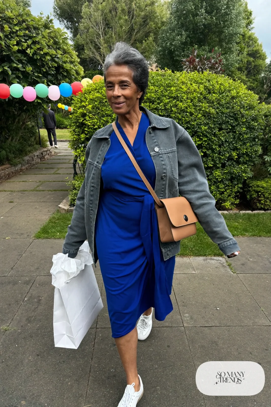 cobalt blue wrap midi dress with gray denim jacket, white sneakers and crossbody bag outfit 4