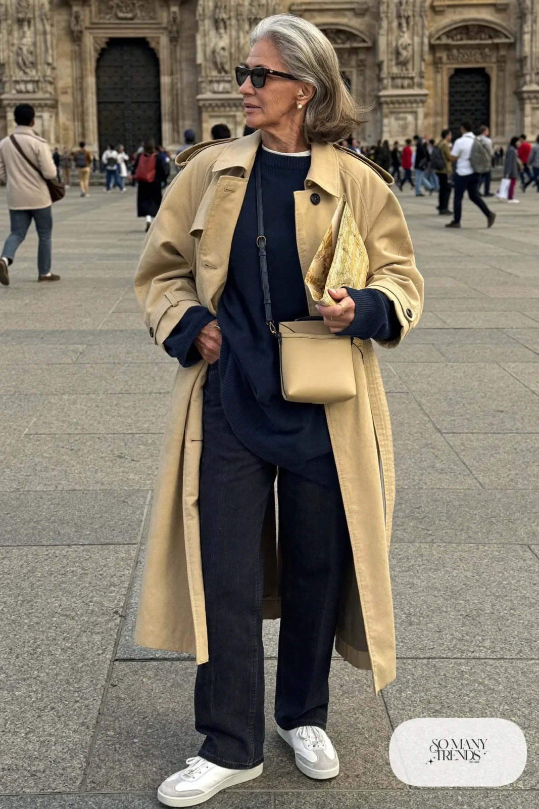 long beige trench coat over navy sweater, dark jeans, white sneakers and crossbody bag outfit 21