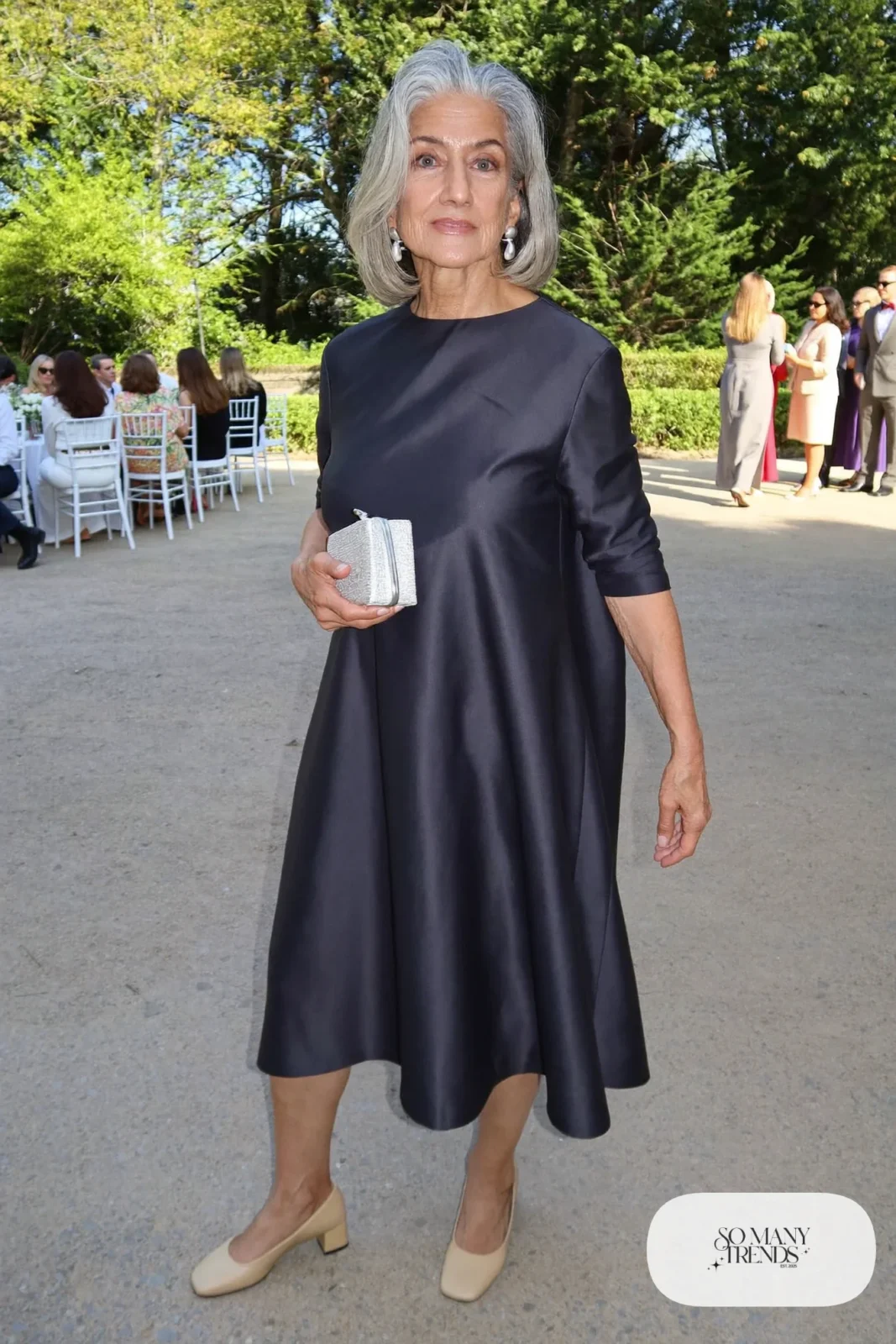 midnight navy A-line midi dress with three-quarter sleeves, silver clutch and low block-heel pumps outfit 27