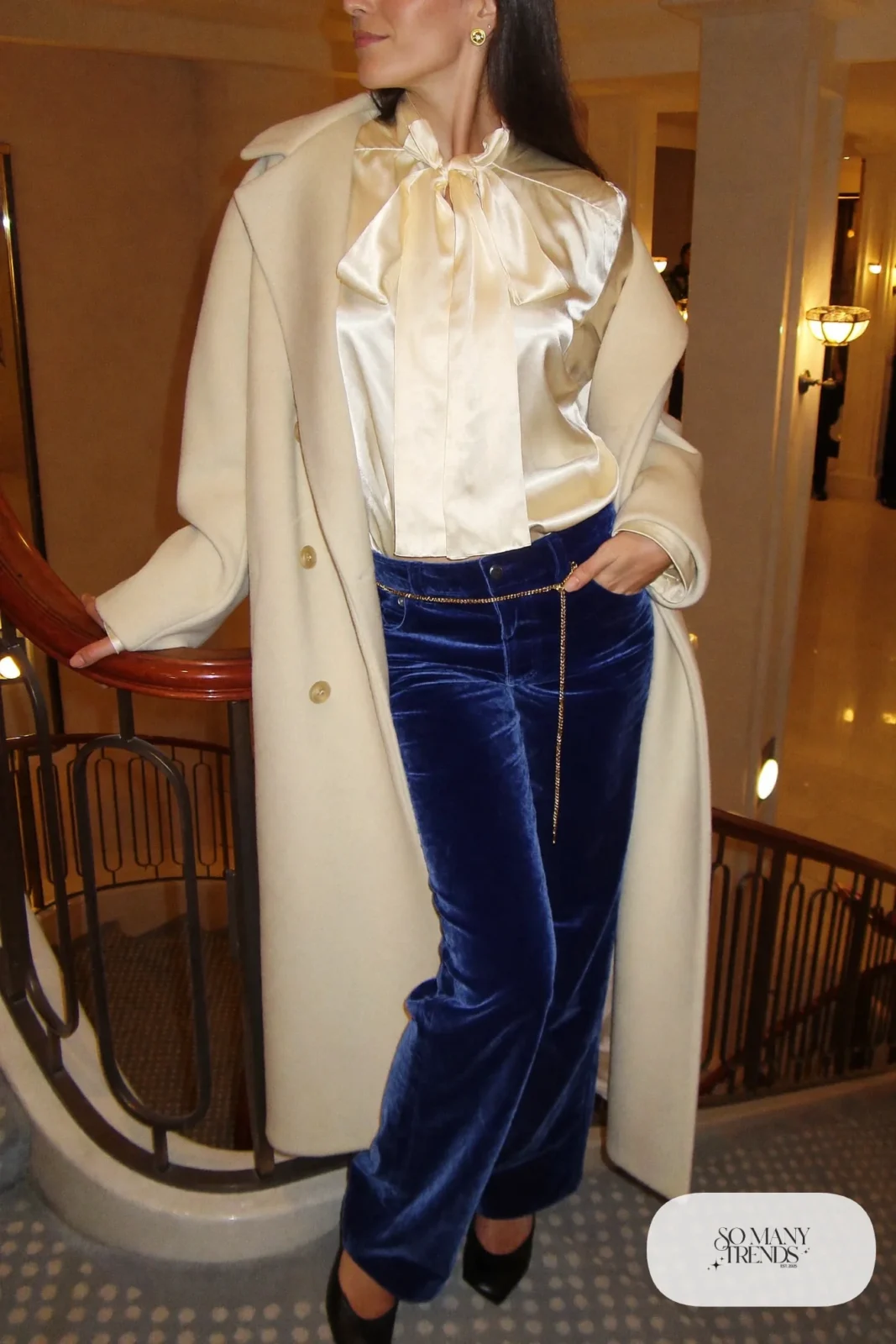 cobalt blue velvet straight leg pants cream silk bow blouse cream wool coat black pumps gold chain belt outfit 18