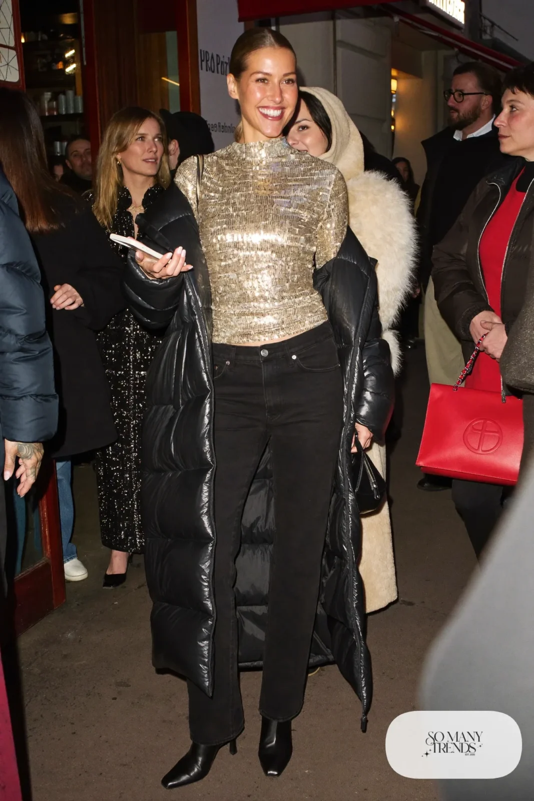 black straight jeans gold sequin long sleeve top long black puffer coat heeled ankle boots outfit 4