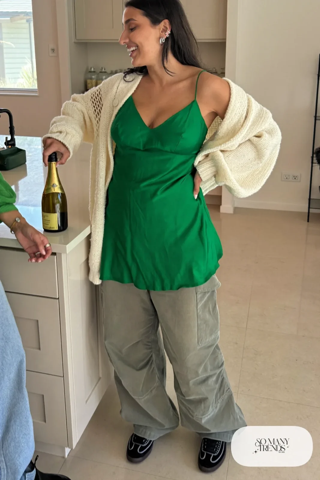 emerald satin camisole gray wide-leg cargo pants cream chunky cardigan black sneakers outfit 3
